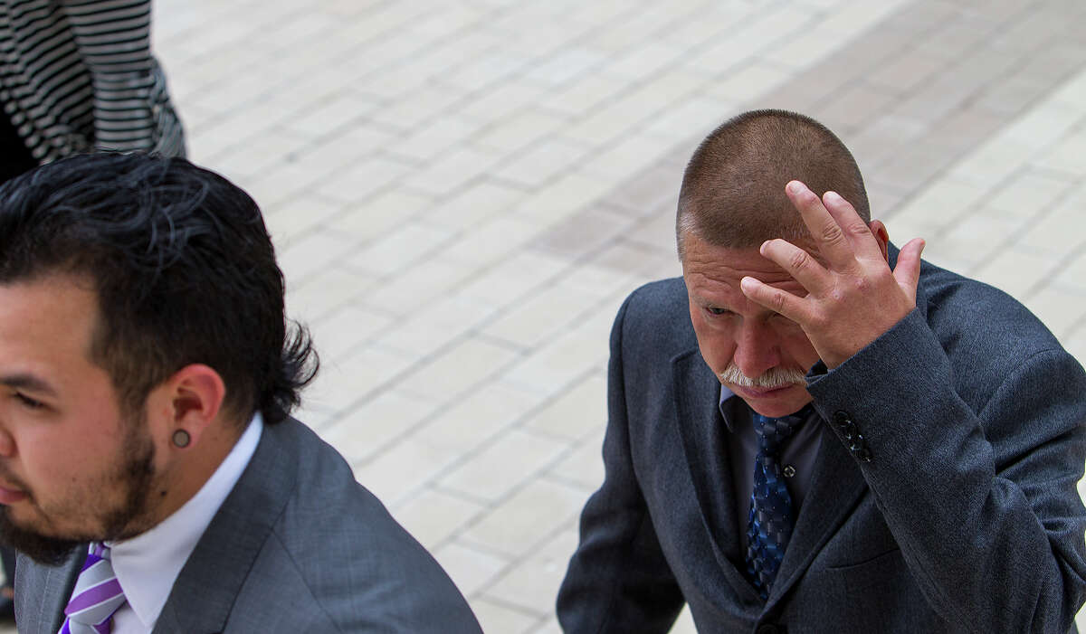 FOR NEWS - Eusevio Maldonado Huitron, right, blocks his face during a trial in which a jury found four of the defendants, men accused of laundering money for the Zetas drug cartel, guilty while Jesus Maldonado Huitron was found not guilty at the United States Federal Courthouse in Austin, Texas on Thursday, May 9, 2013. MICHAEL MILLER / FOR THE EXPRESS-NEWS