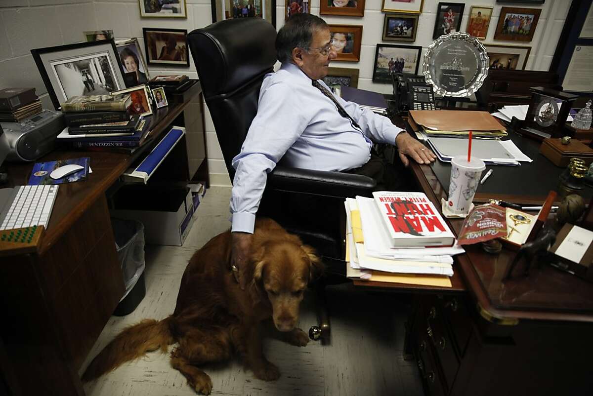 Former Defense Secretary Leon Panetta pats his dog Bravo while sitting at his desk in his office at The Panetta Institute for Public Policy on Tuesday, April 16, 2013 in Seaside, Calif.