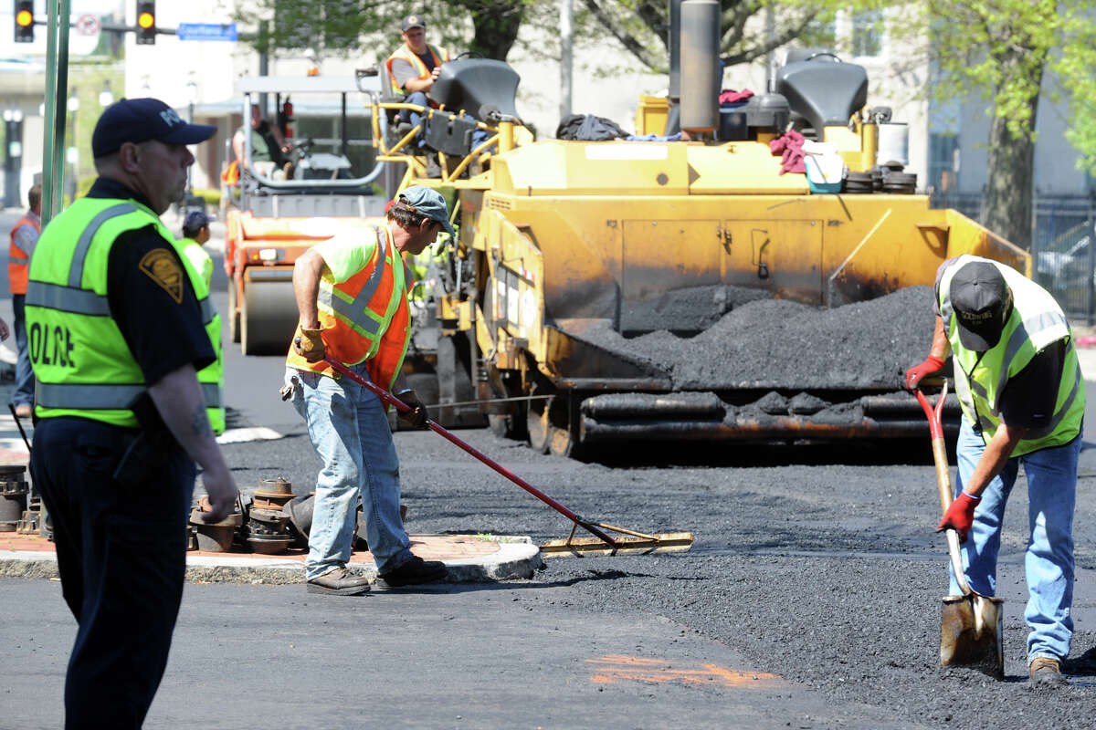 Hot asphalt is laid down on John Street, in Bridgeport, Conn., May 10th, 2013. Traffic throughout downtown has been detoured in various directions for a couple of weeks during the major paving project.