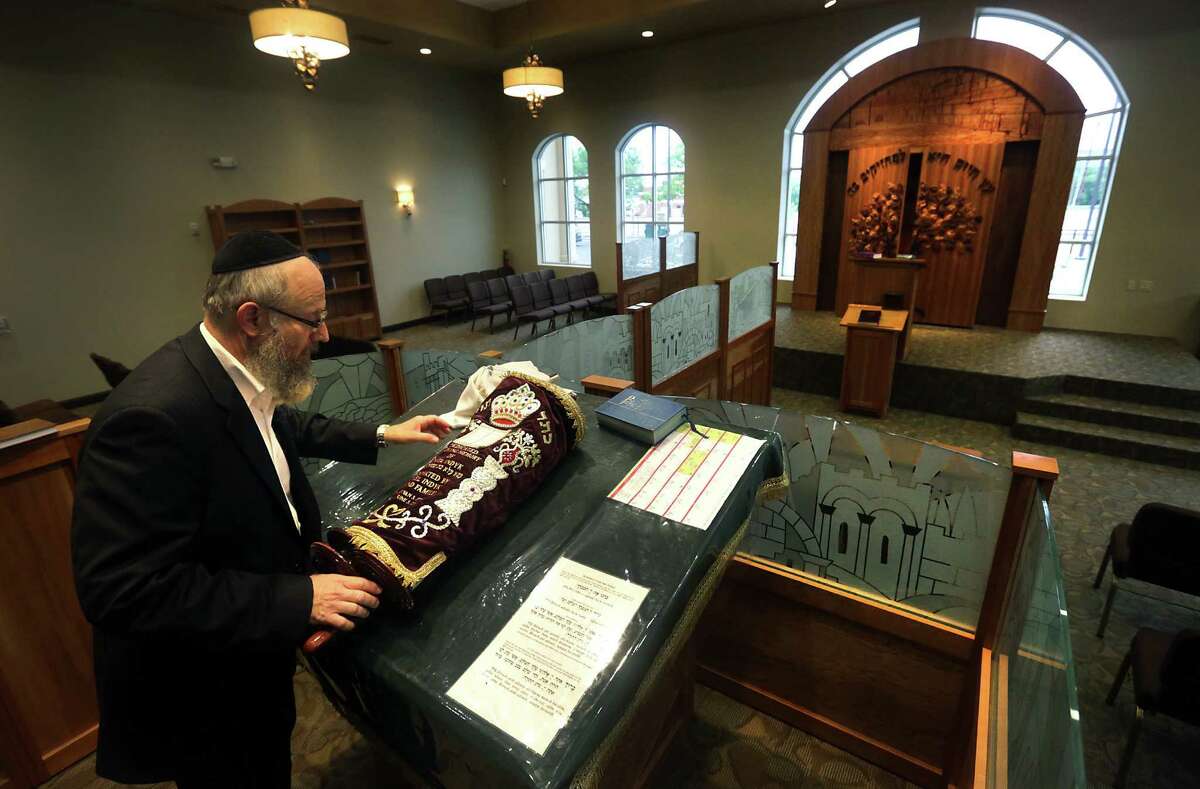 Rabbi Chaim Block places the Torah on the Bema in the new Orthodox synagogue, which sits on 4 acres on Blanco Road.