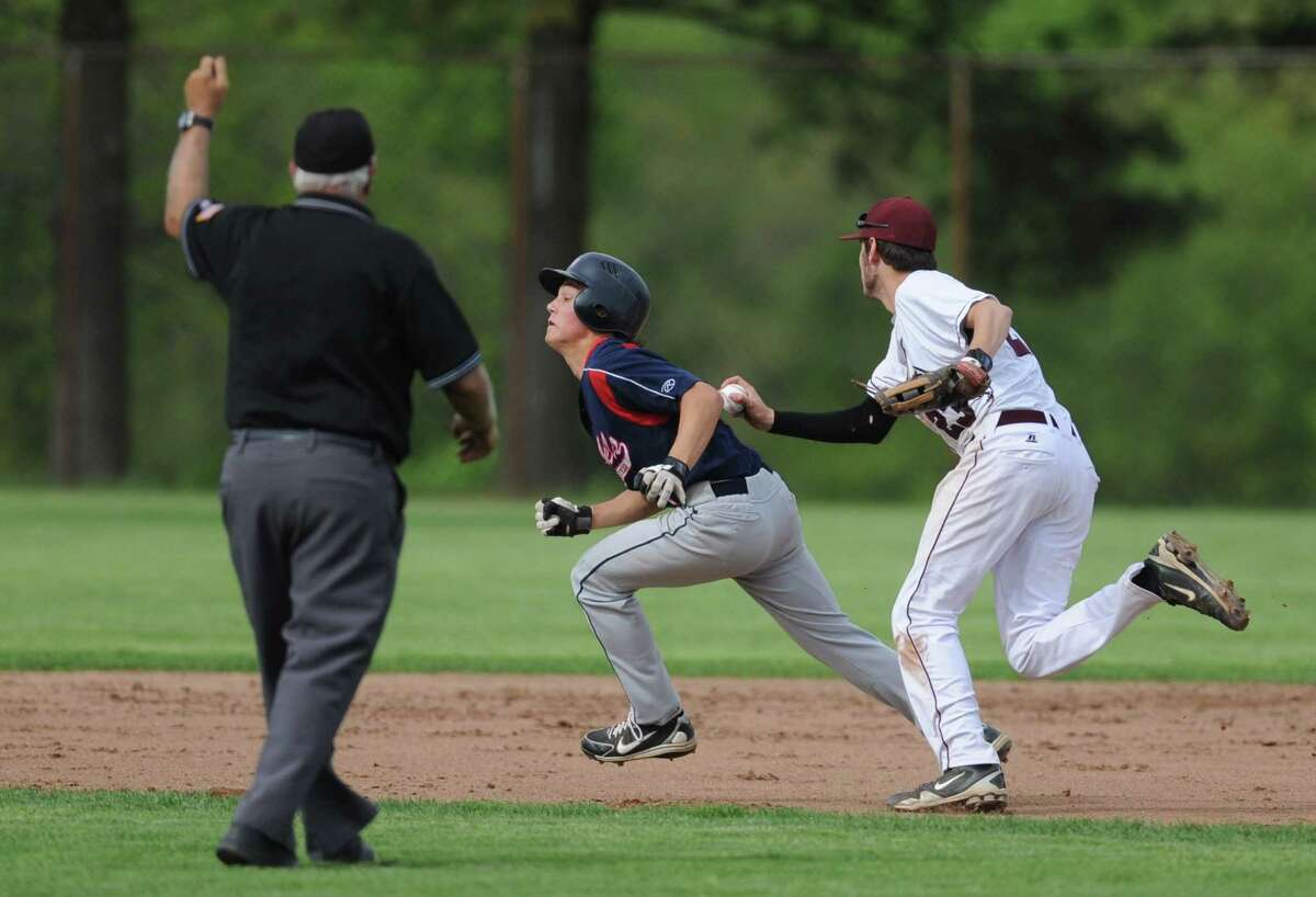 Bethel first baseman Daniel Simonelli tags out New Fairfield baserunner Joseph Hicks on a play that was later determined to be a balk during the Bethel baseball team's 3-1 win over New Fairfield at Bethel High School in Bethel, Conn. on Friday, May 10, 2013.