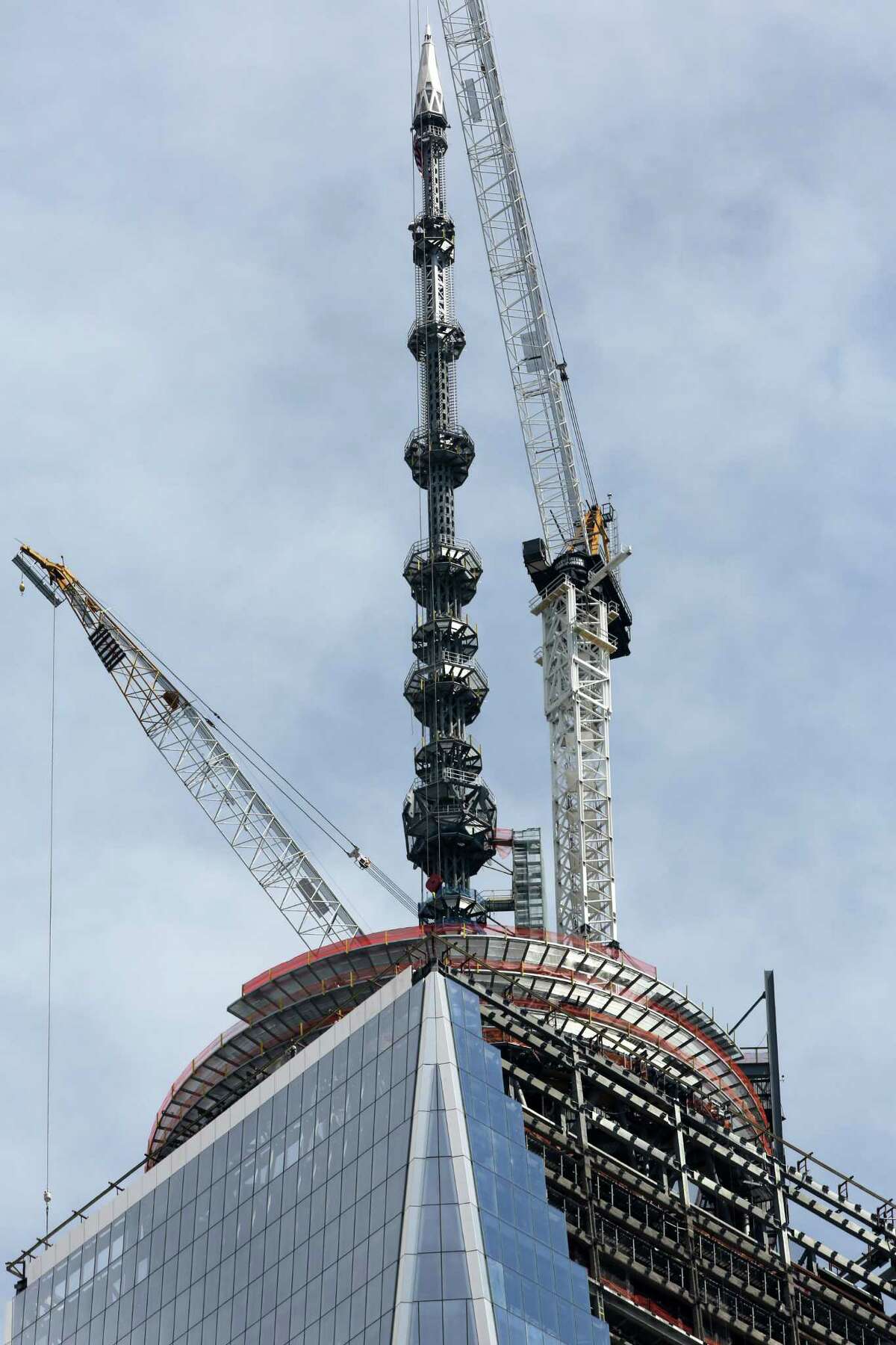 The 408-foot spire at the top of One World Trade Center is seen from lower Manhattan, Friday, May 10, 2013. The tall, heavy spire was fully installed Friday, bringing One World Trade Center to its symbolic height of 1,776 feet.