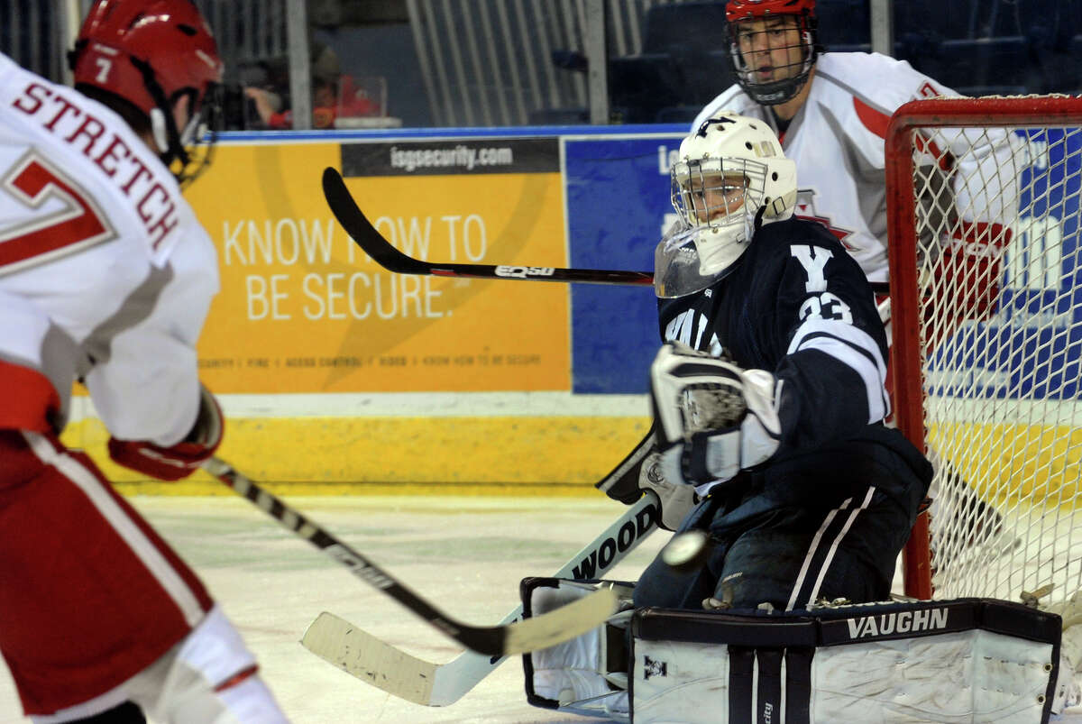 Sacred Heart University's #7 Mitchell Stretch, left, looks to get the puck past Yale goalie Jeff Malcolm, during men's ice hockey action at the Webster Bank Arena in Bridgeport, Conn. on Tuesday November 22, 2011.