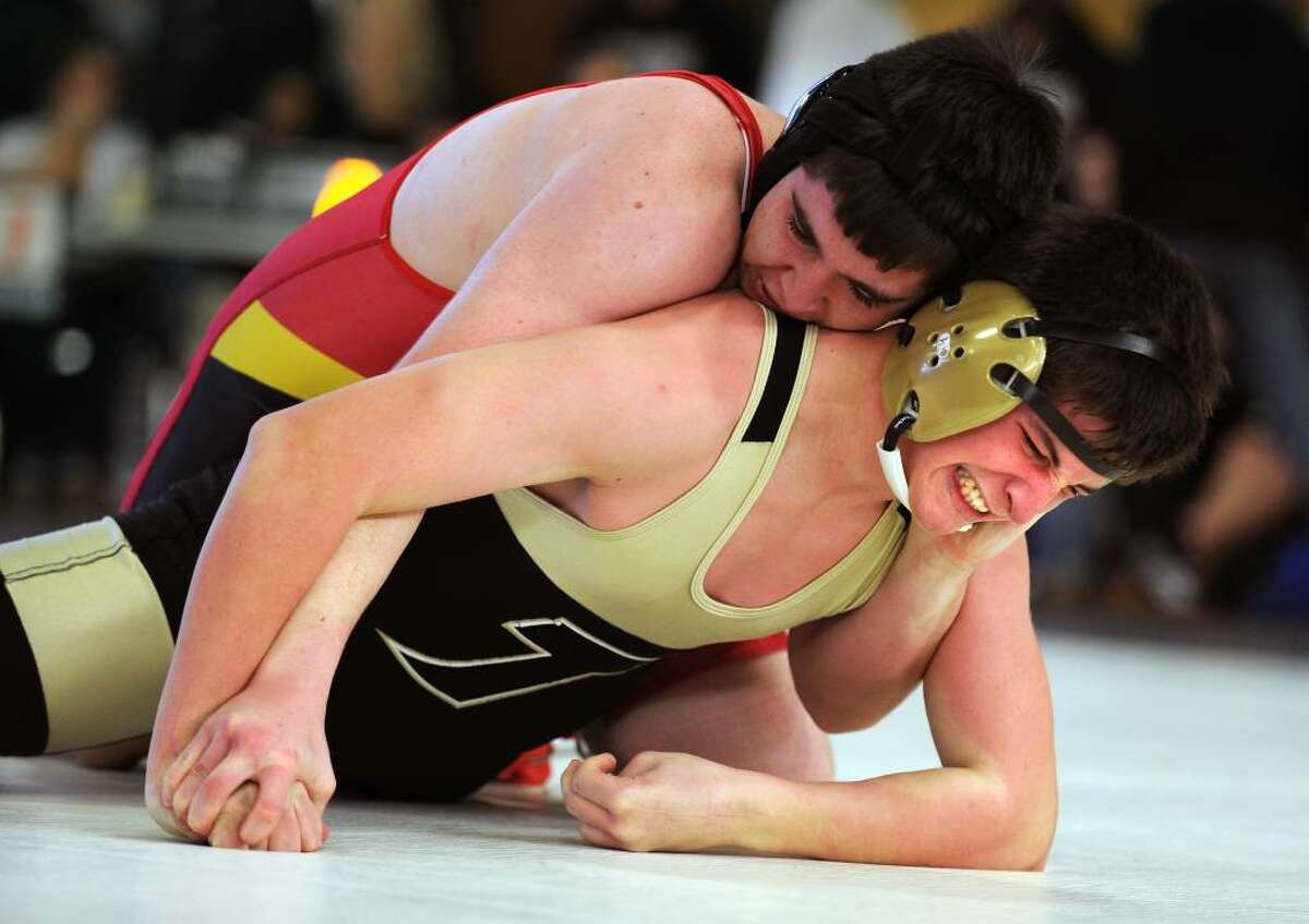 Stratford's Mike Fahey tries to hold down Trumbull's James Lindine during their bout in the 160 lb weight class at Saturday's wrestling tournament held at Trumbull High School.