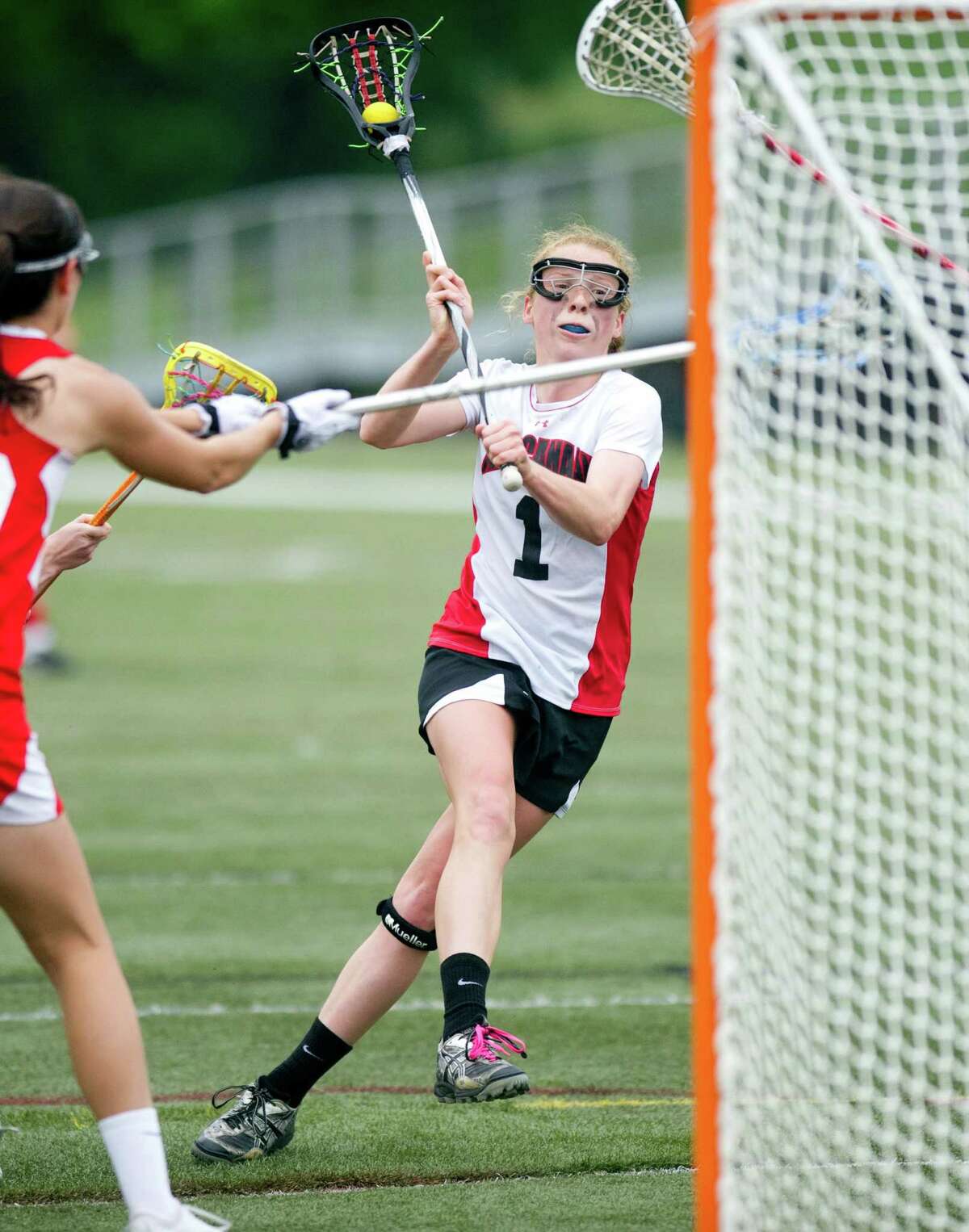 Elizabeth Miller scores a goal during Saturday's girls lacrosse game at New Canaan High School against Fox Lane on May 11, 2013.