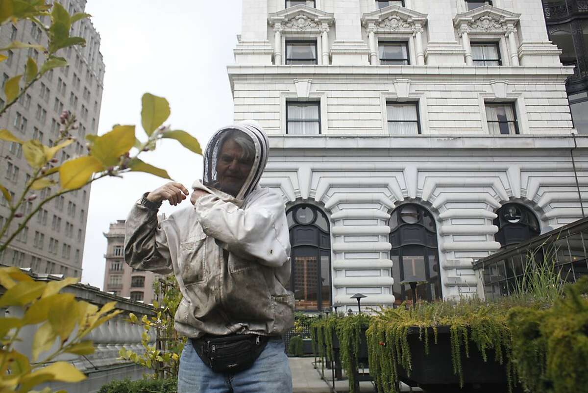 Master beekeeper Spencer Marshall zips up his bee suit before tending to four double queen beehives on the roof of the Fairmont Hotel in San Francisco.