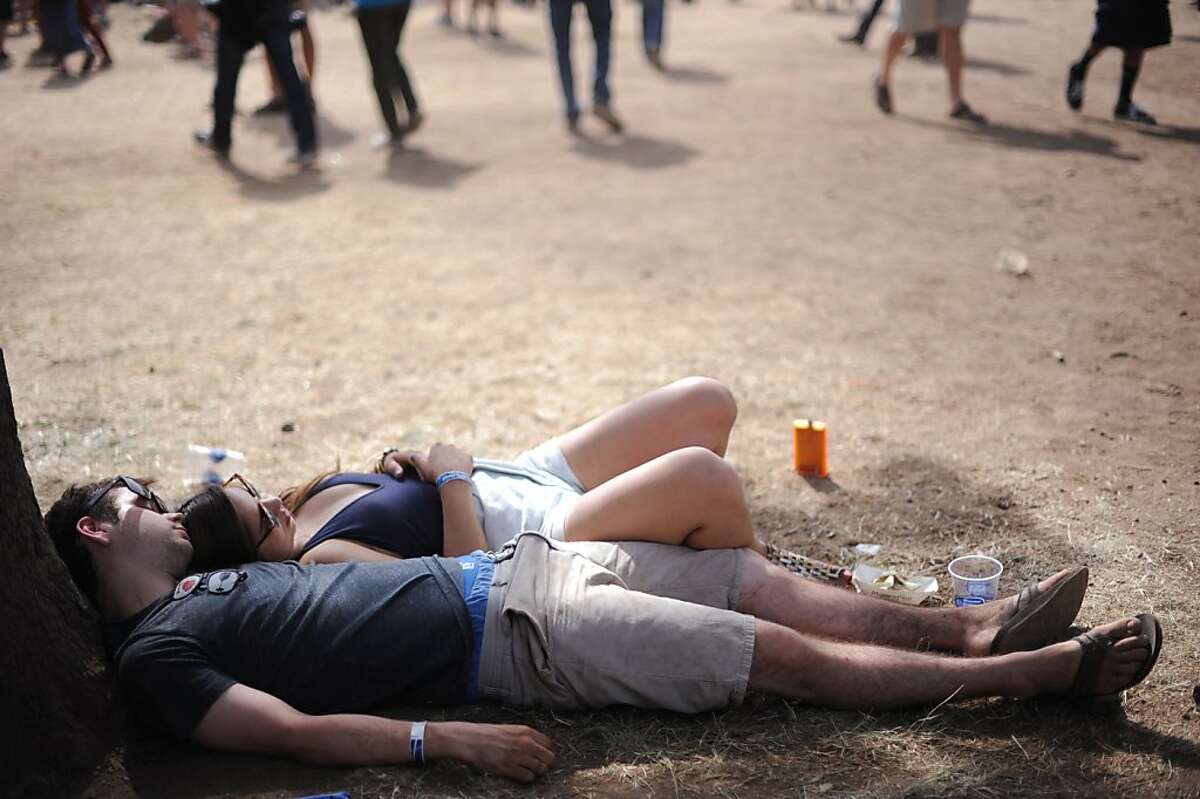 Garett Melin of Temecula, California and Kristyn Carter of Antioch, California taking a break from the heat during the Bottle Rock Napa Valley festival Saturday. May 11, 2013.