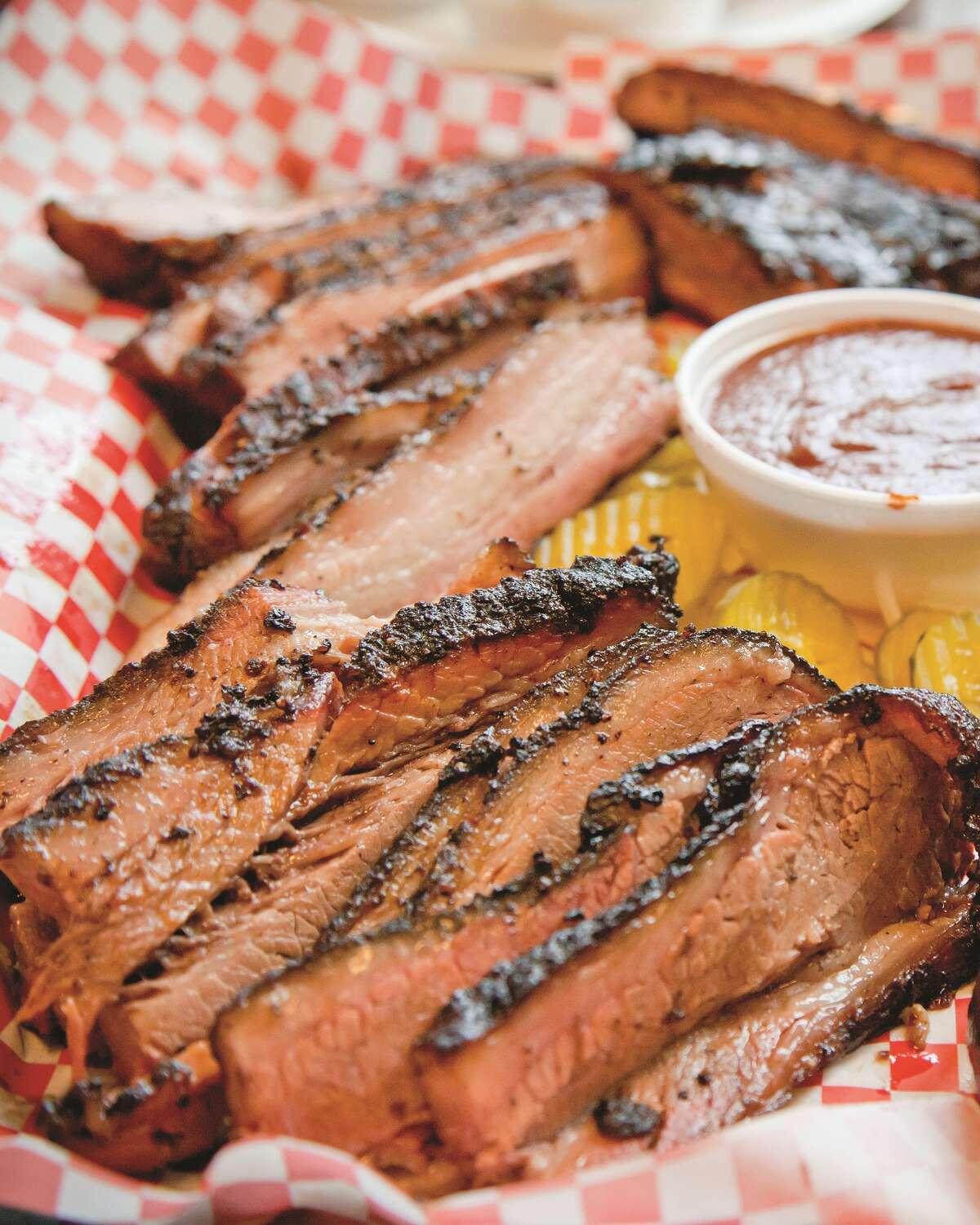 Pecan Lodge Sausage and brisket are the Pecan Lodge, located in Dallas. Fans say the meat is served "Texas style," meaning no sauce is required, and it has a smokey taste. The restaurant is family owned, and was named one of the Top 4 BBQ joints in the world by Texas Monthly.