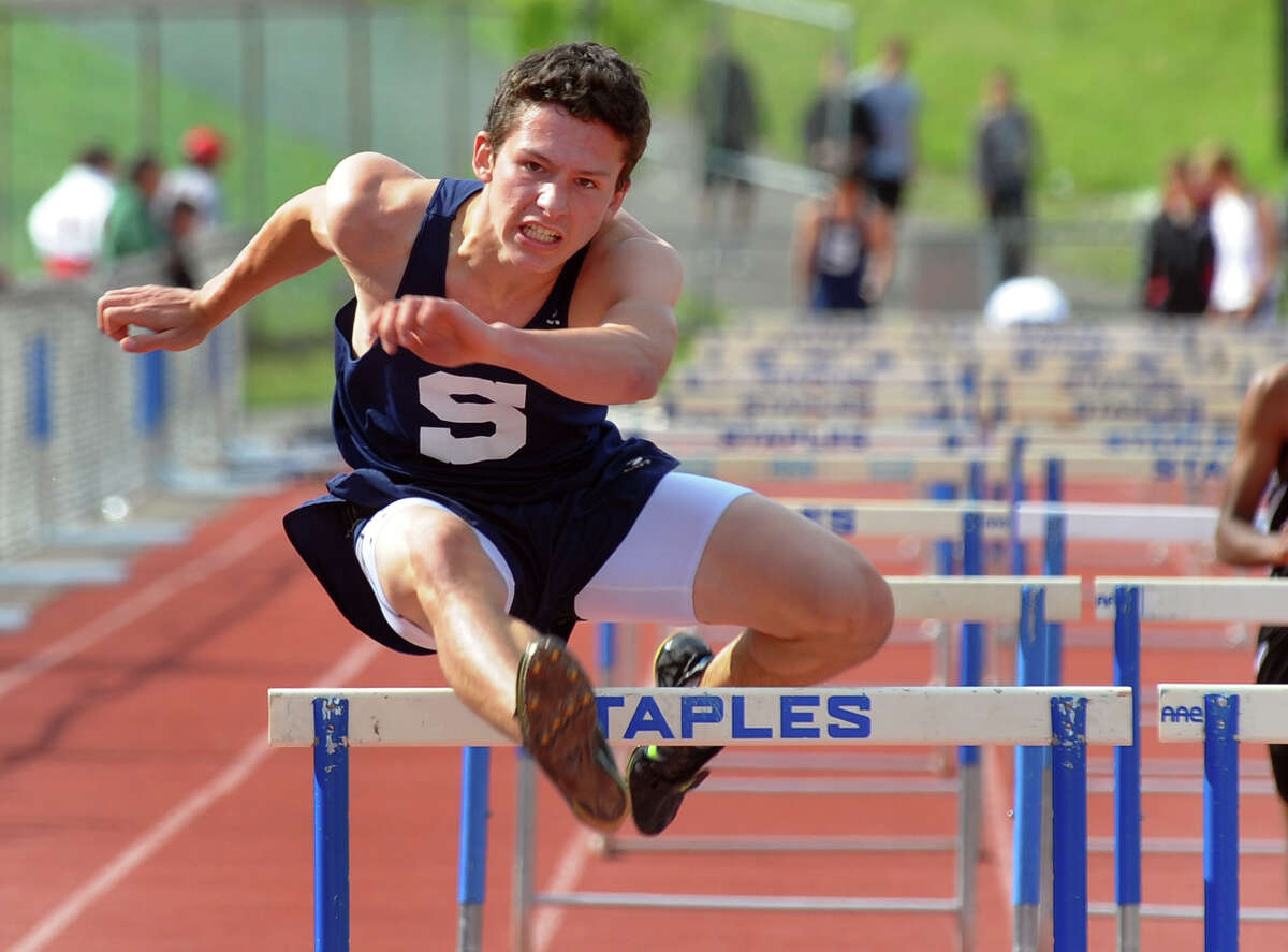Staples Bobby Jacowleff clears the final hurdle in the 110 meter hurdles event, during track action against Fairfield Warde and New Canaan at Staples in Westport, Conn. on Tuesday May 14, 2013.