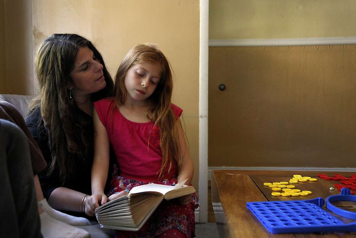 Beth Jaeger-Skigen reads with her daughter Hana, 8, after school at their home in San Francisco, Calif., on Tuesday, May 14, 2013. Jaeger-Skigen had a double mastectomy about 5 years after testing positive for the BRCA2 mutation. She said though it was hard, the decision was easy. Her twin daughters were "99% of the motivation" to have the surgery.