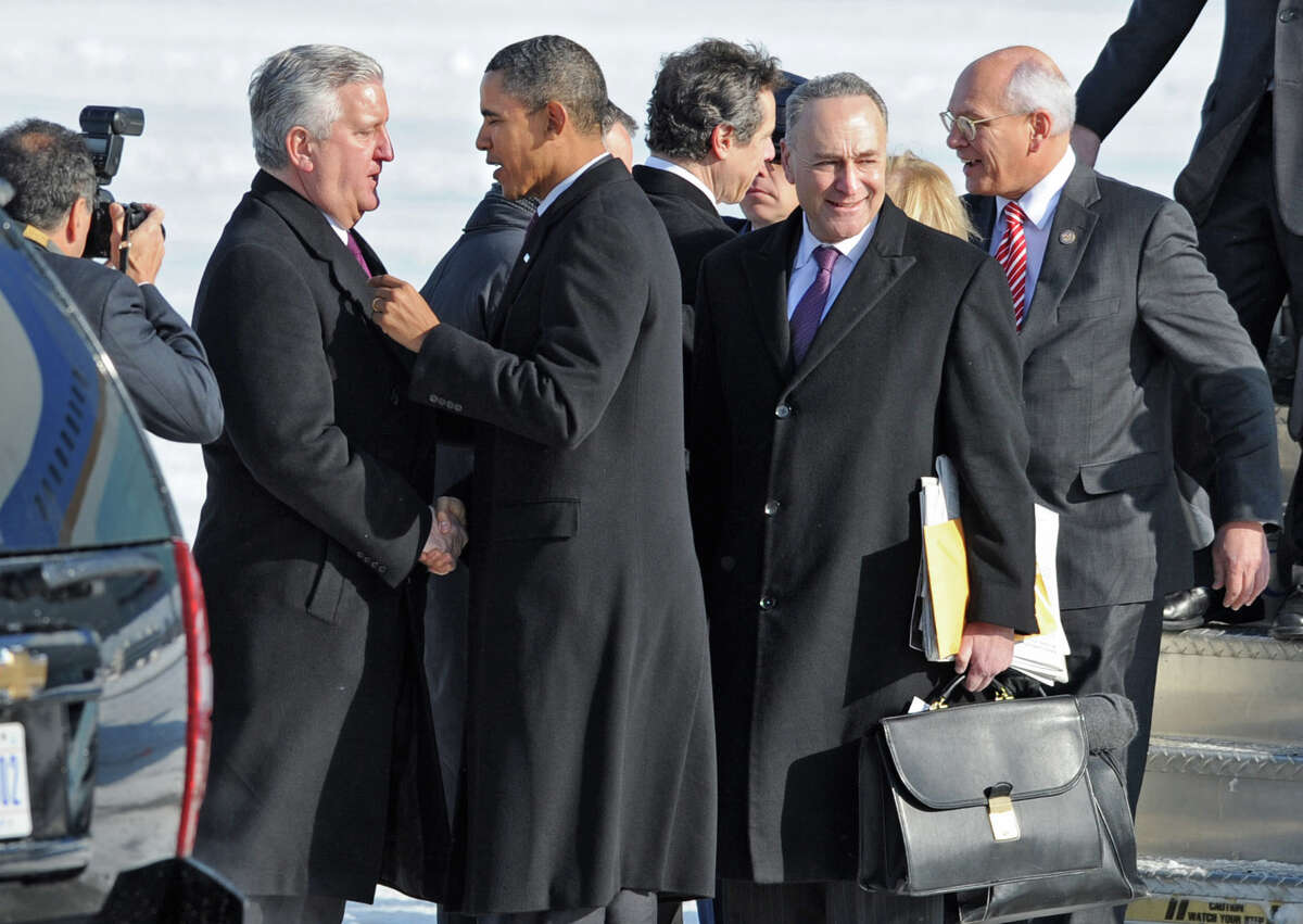 U.S. President Barack Obama is greeted my Albany Mayor Jerry Jennings as he leaves Air Force One after landing at the Albany International Airport in Colonie, NY on January 21, 2011. U.S. Senator Chuck Schumer, U.S. Senator Kirsten Gillibrand and U.S. Representative Paul Tonko follow him off the plane. The President is scheduled for a brief tour of the General Electric Plant in Schenectady. (Lori Van Buren / Times Union)