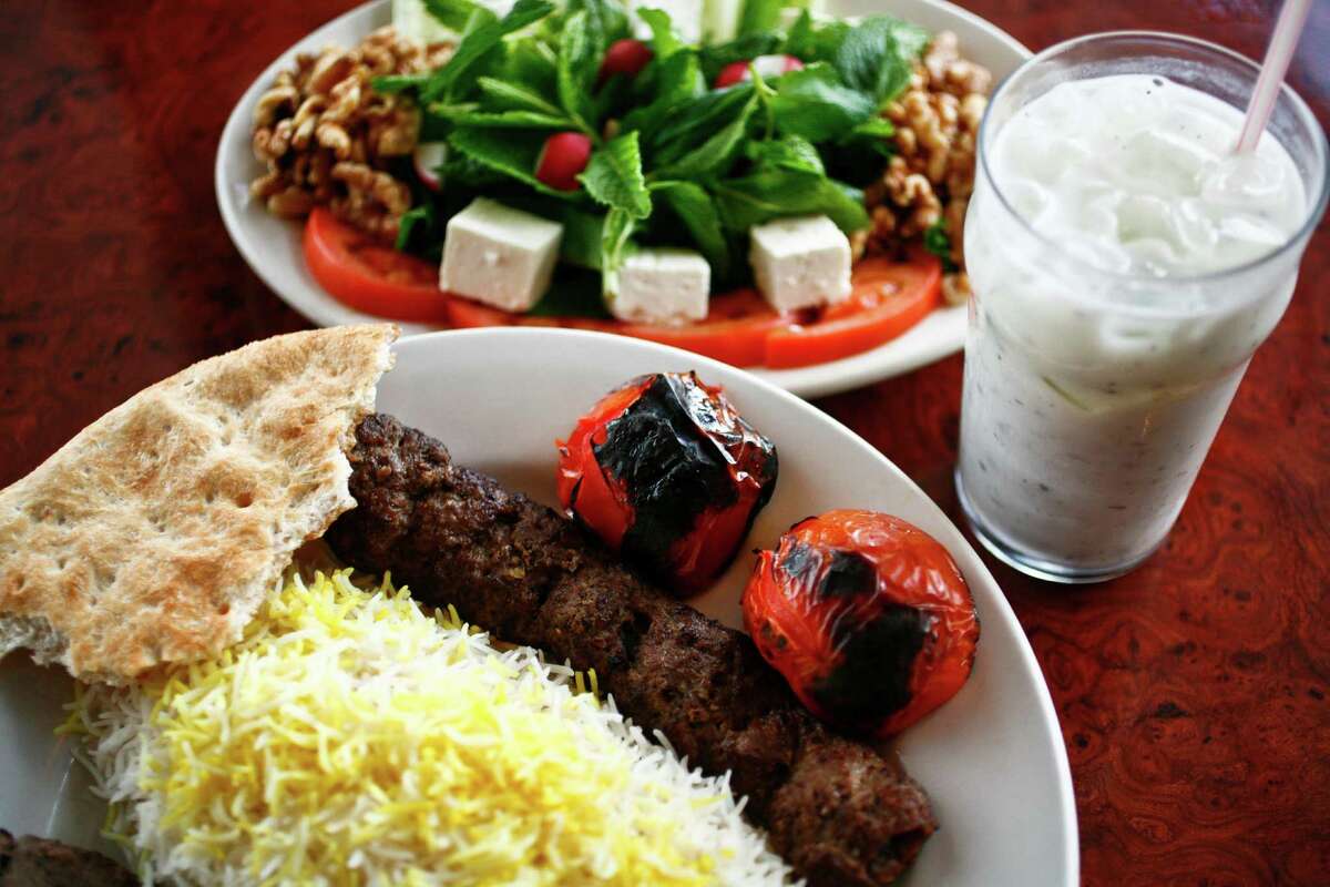The Sultani, a skewer of beef Kubideh and a skewer of beef Barg along with white rice, the Special Herb Plate and a cup of Doogh, a yogurt drink, at Kasra Persian Grill Tuesday, June 15, 2010, in Houston. ( Michael Paulsen / Houston Chronicle )