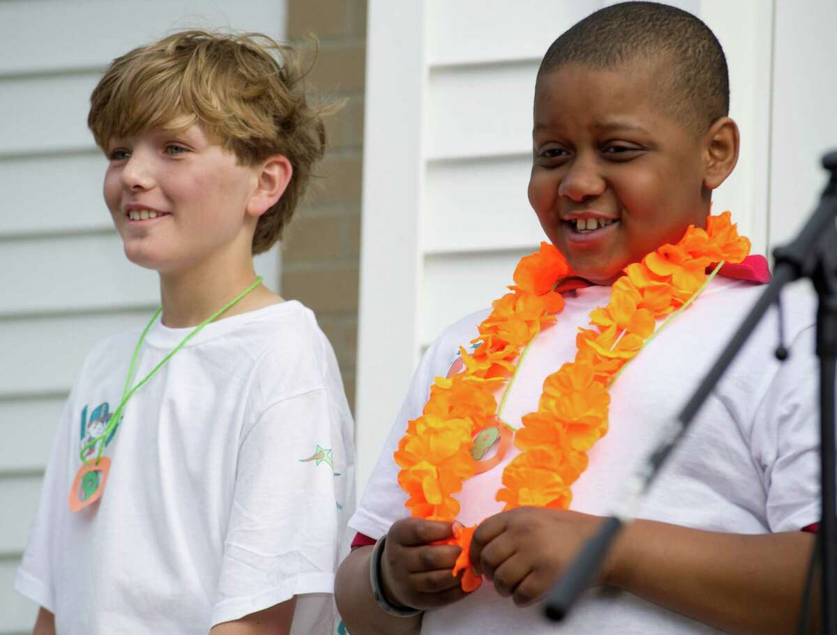 Kyle Markes, right, smiles as he stands next to classmate William Staniar, left, during "5B Cares" at New Canaan Country Day School on Wednesday, May 15, 2013.