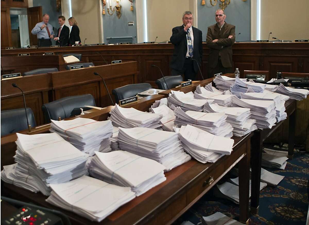 Stacks of paperwork await members of the House Agriculture Committee, on Capitol Hill in Washington, Wednesday, May 15, 2013, as it meets to consider proposals to the 2013 Farm Bill, including small cuts to the $80 billion-a-year food stamp program in an effort to appease conservatives who say the food aid has become too expensive. (AP Photo/J. Scott Applewhite)