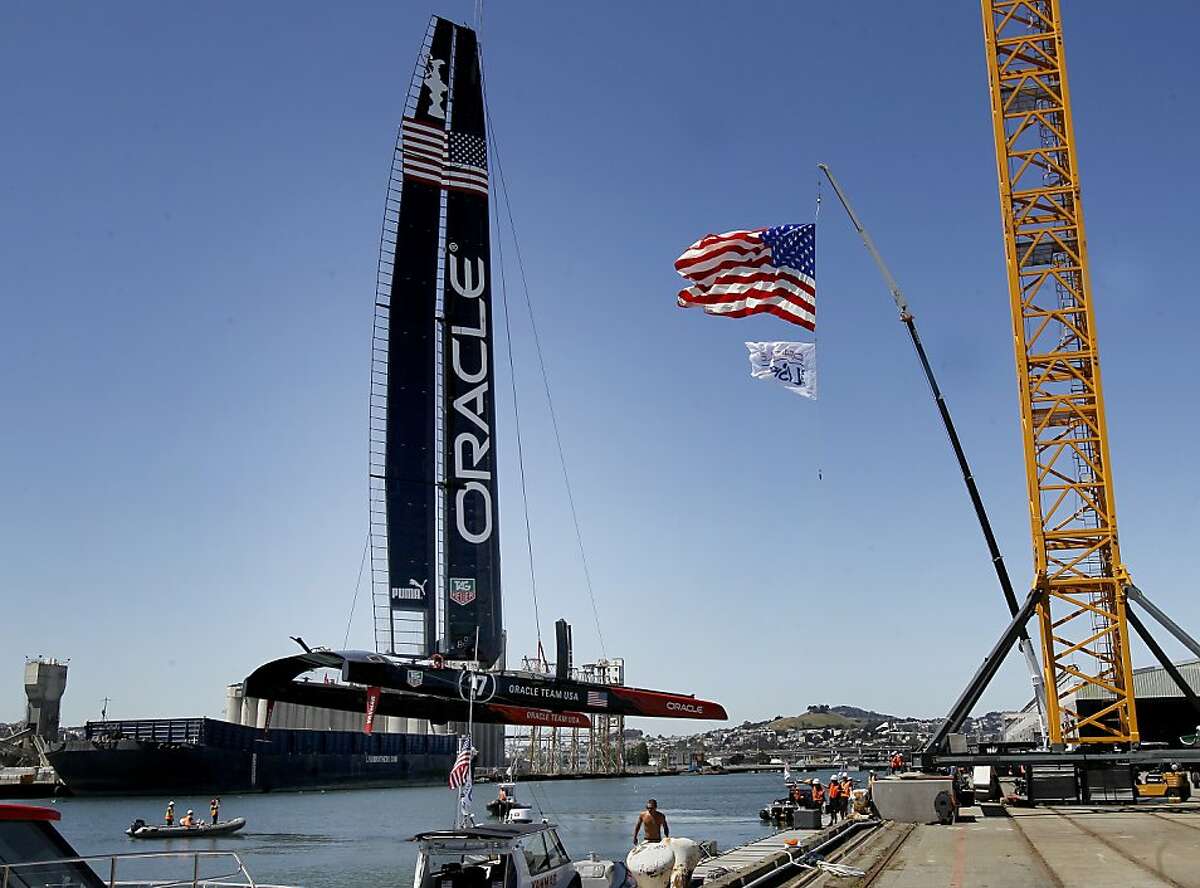 A large crane lifted the catamaran into the water next to the Oracle Team USA headquarters. To much fanfare, Oracle Team USA launched its new AC72 yacht Tuesday April 23, 2013 at their base headquarters near Marin Street in San Francisco, Calif.
