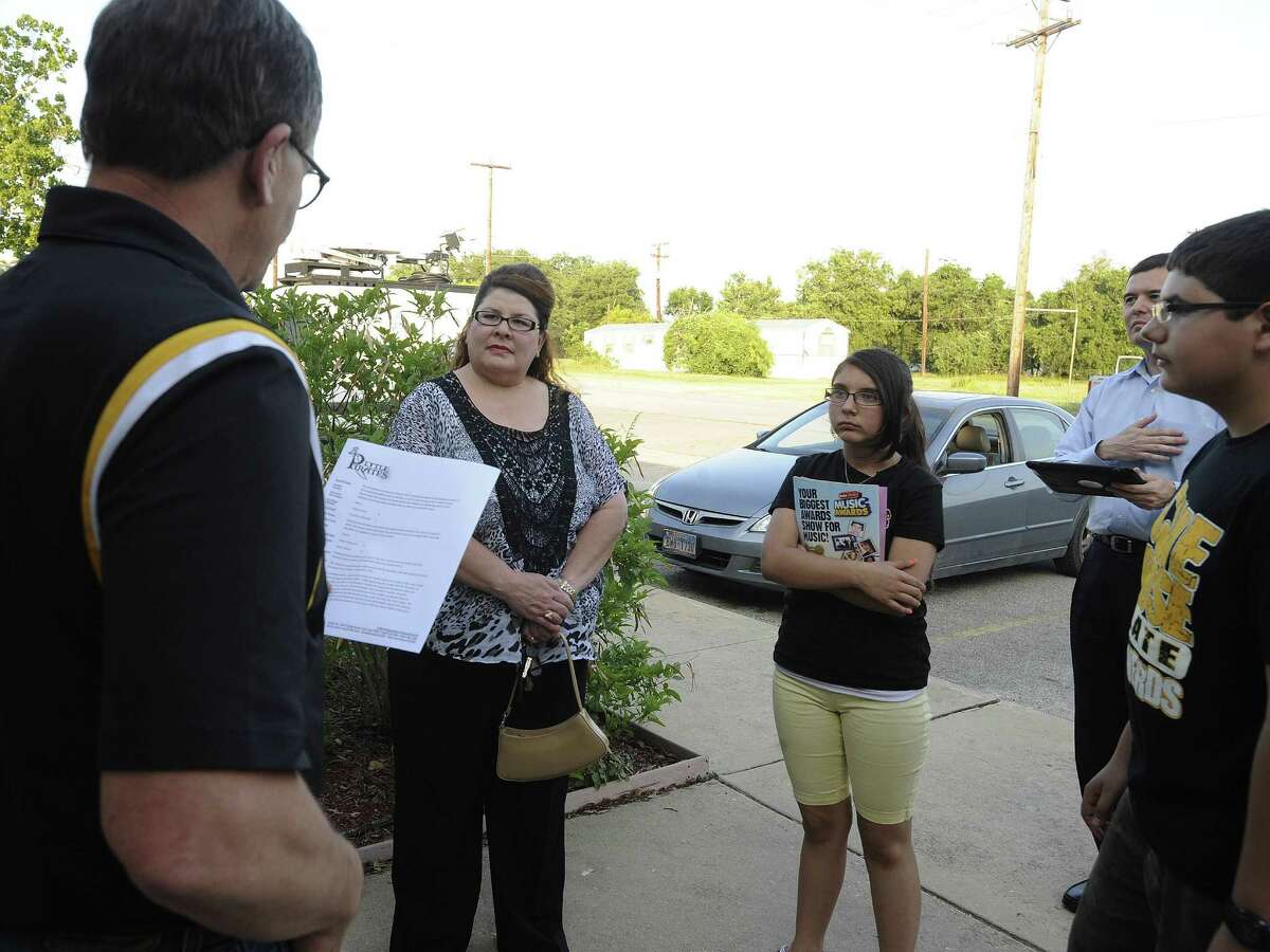 Christina Mercado (second from left) listens as Randy Ewing, a Lytle ISD spokesman (left) announces that Mercado's 1-0 victory in Saturday's school board election will stand.