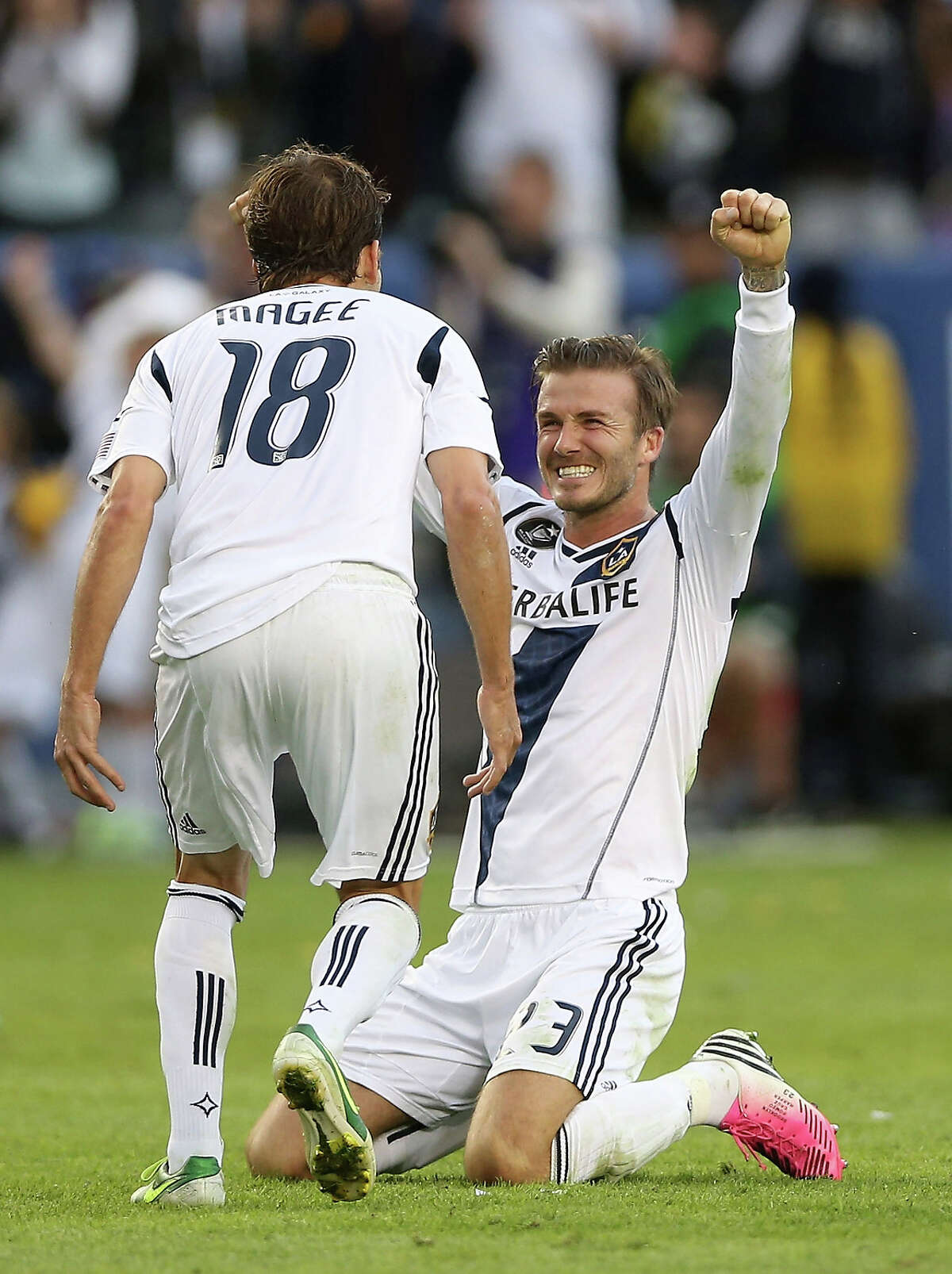 David Beckham #23 and Mike Magee #18 of Los Angeles Galaxy celebrate in the second half against the Houston Dynamo in the 2012 MLS Cup at The Home Depot Center on December 1, 2012 in Carson, California.