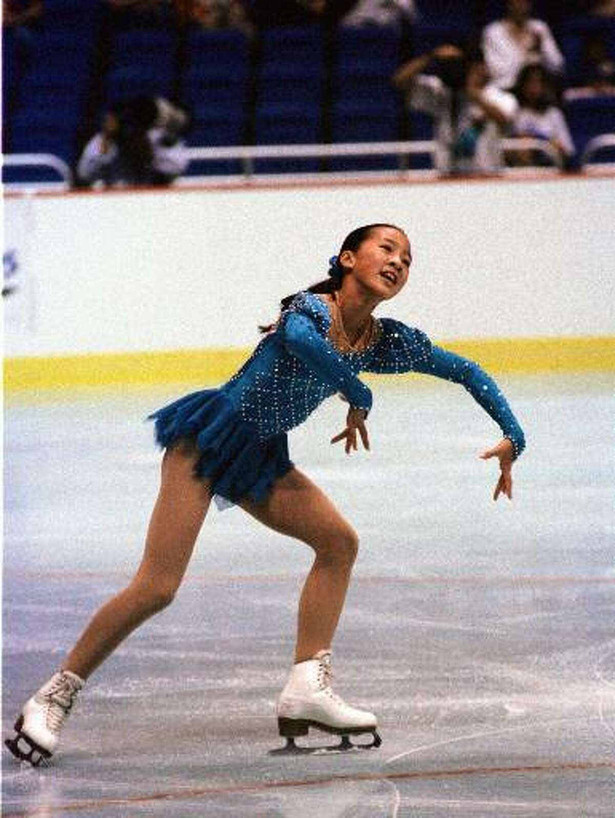 Olympic skater Michelle Kwan skates in the Alamodome during the Olympic Festival, July 24, 1993. Her performance captivated 25,691 patrons at the Alamodome, and they gave her a standing ovation as she left the ice. Several fans threw roses and other flowers onto the ice as she glided for a victory lap after claiming the gold medal.