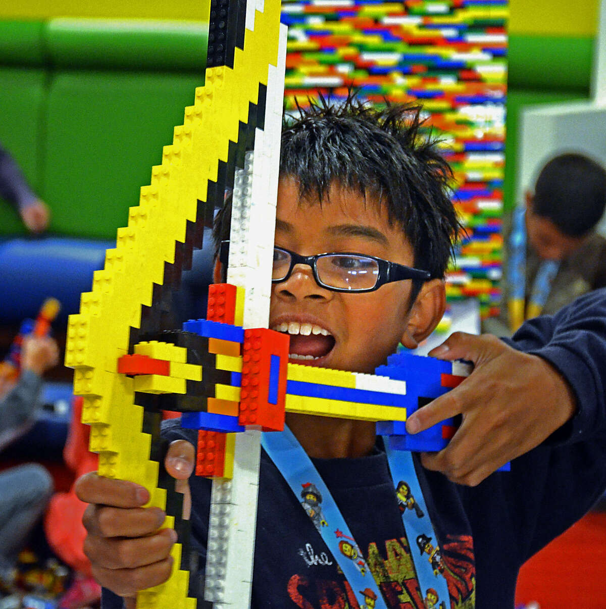 Mason Eugenio, 11, plays with a bow he made from Lego pieces. Legos are the No. 1 toy sought by boys.