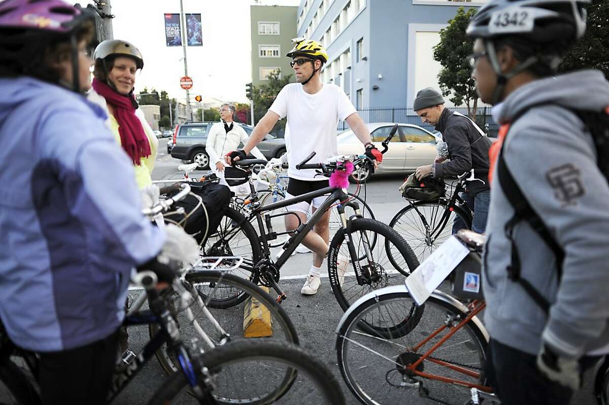    Participants in the Ride of Silence pause at the intersection of Oak and Franklin streets, where a cyclist was killed.  