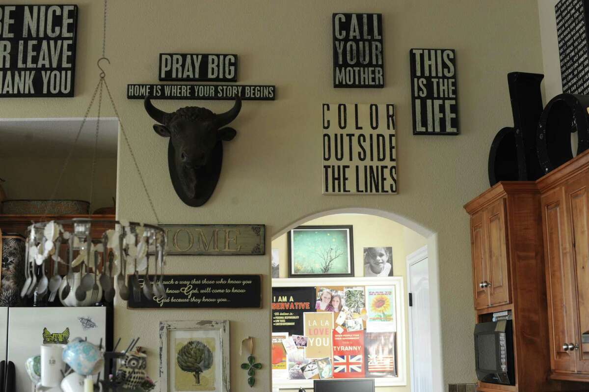Typography prints decorate the walls in the kitchen of Denise and Mickey Hubicsak's home in New Braunfels. “Call Your Mother” is everybody's favorite.