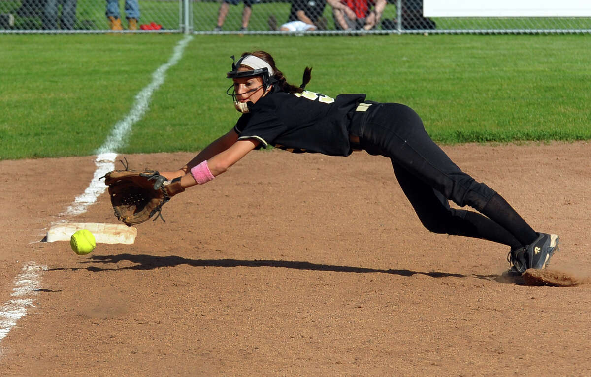 Jonathan Law third baseman Stephanie Peloso dives for a Foran grounder, during softball action in Milford, Conn. on Friday May 17, 2013.