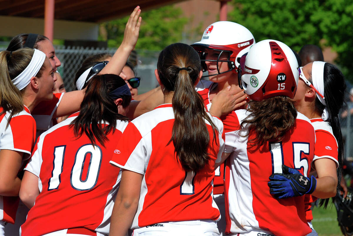 Foran teammates surround Fallon Bevino after she hit a two run homer, during softball action against Jonathan Law in Milford, Conn. on Friday May 17, 2013.