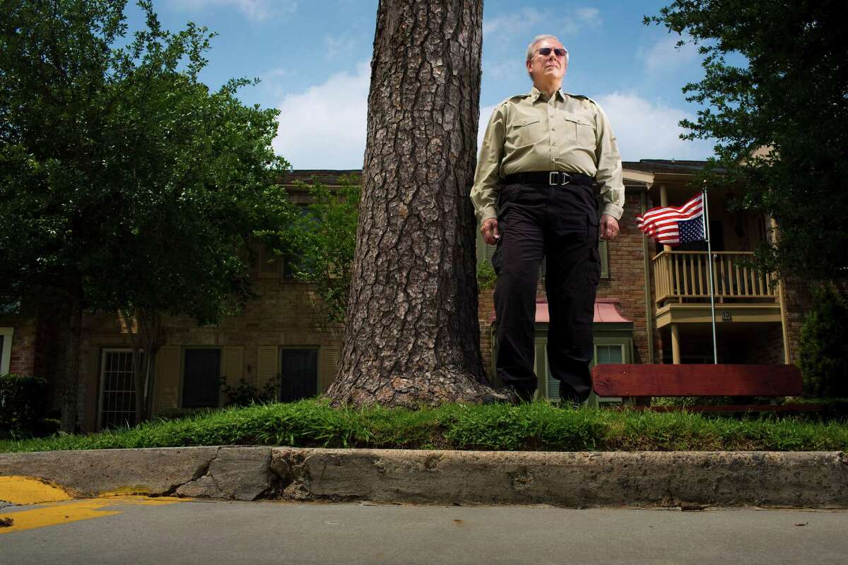 Billy Martin poses in front of his Houston townhouse. A similar case two years ago spawned a new state law protecting flag displays from HOA rules. The same lawyer who represented that homeowner is Martin's pro bono lawyer.
