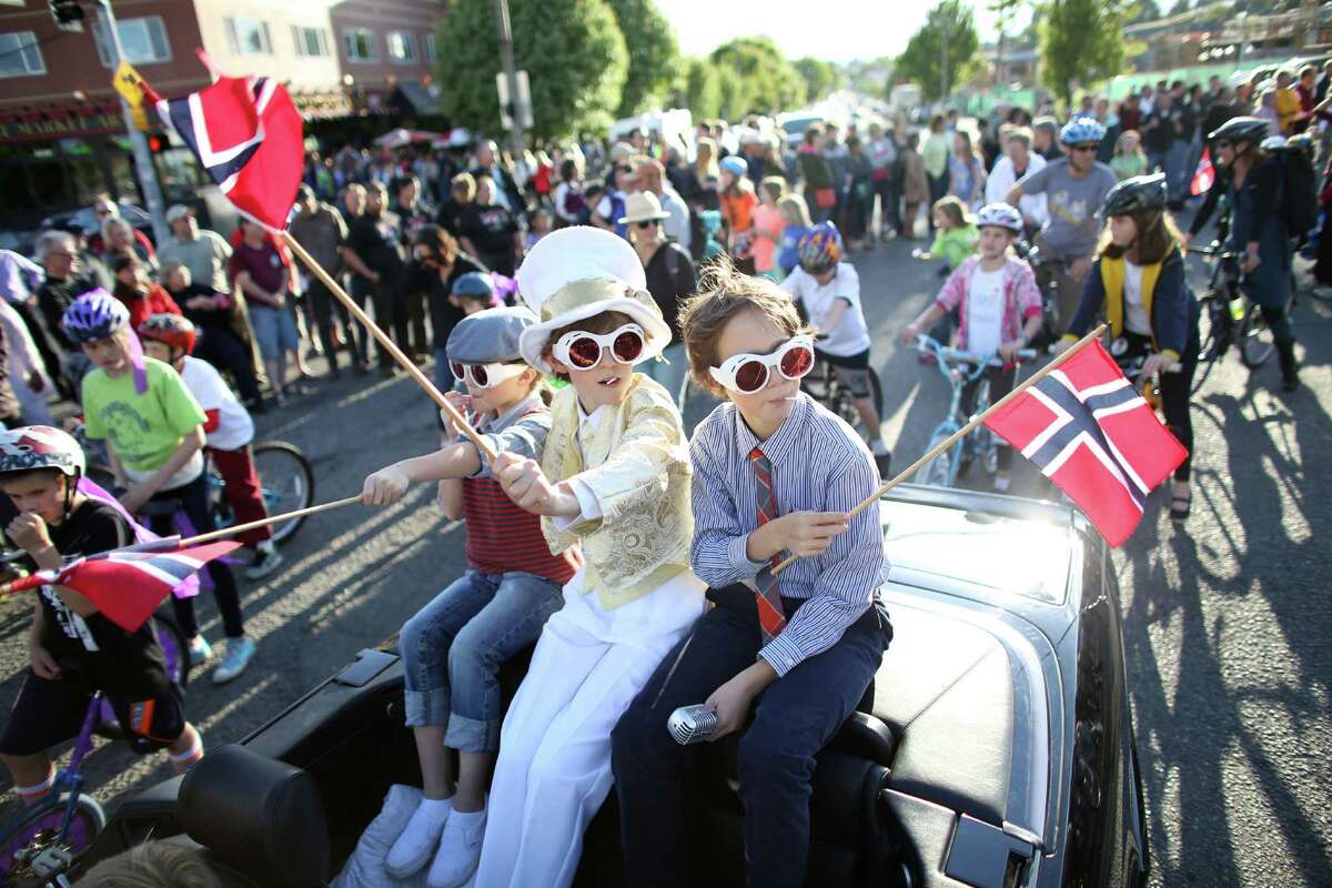 Students from Loyal Heights Elementary ride in a convertible during Ballard's annual Syttende Mai parade. The parade celebrates Norwegian Constitution Day and is one of the largest celebrations outside of Oslo. Photographed on Friday, May 17, 2013.