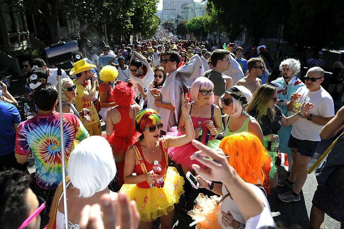 Crowds of people dance on Hayes St. during the 102nd Bay to Breakers race in San Francisco, CA Sunday May 19th, 2013.
