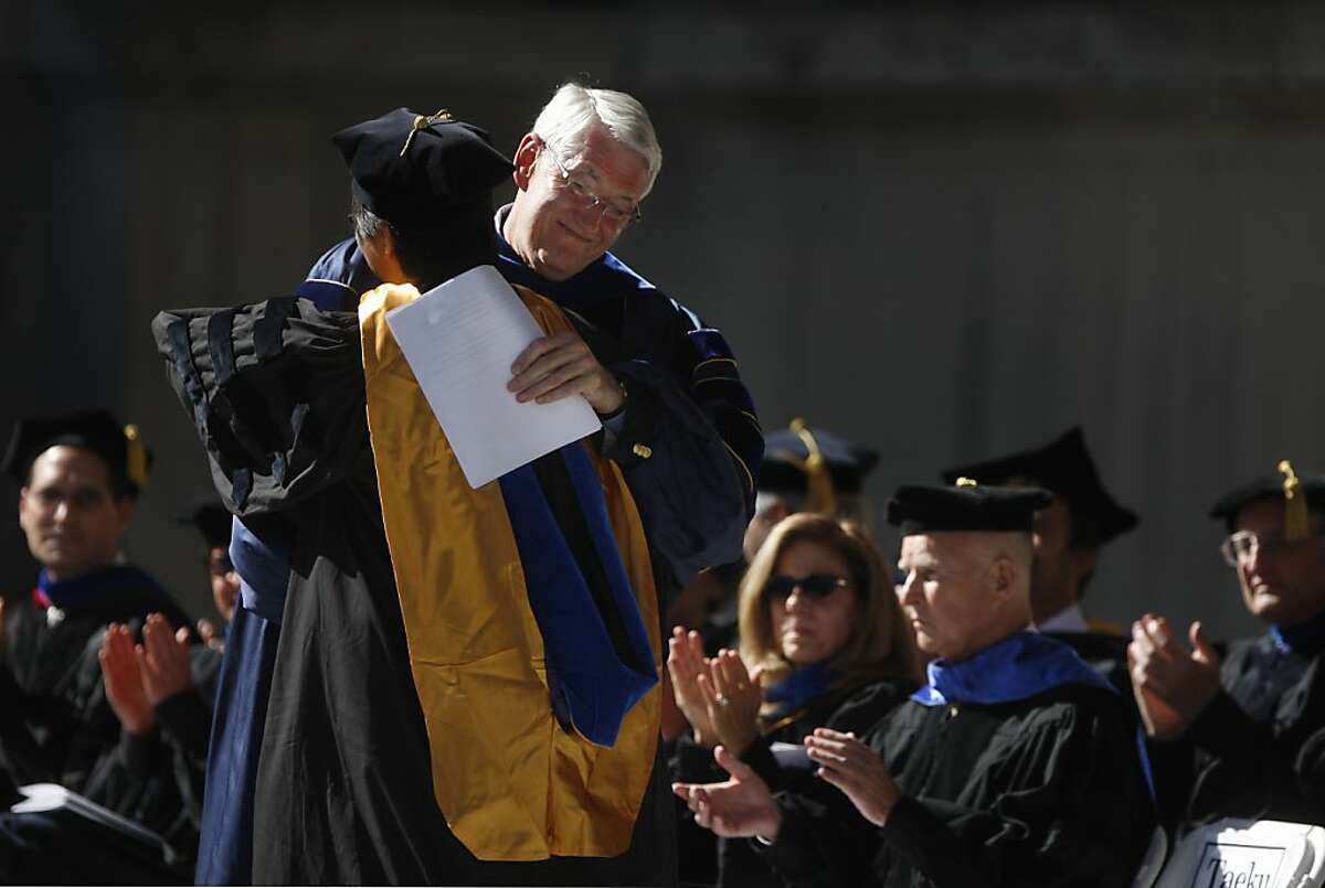 Chair, Department of Political Science, Professor Taeku Lee (left, view of back) and Chancellor, University of California, Berkeley Professor Robert Birgeneau (facing right) greet each other on stage at the Charles and Louise Travers Department of Political Science University of California, Berkeley Commencement Ceremony on Monday, May 20, 2013 in Berkeley, Calif.