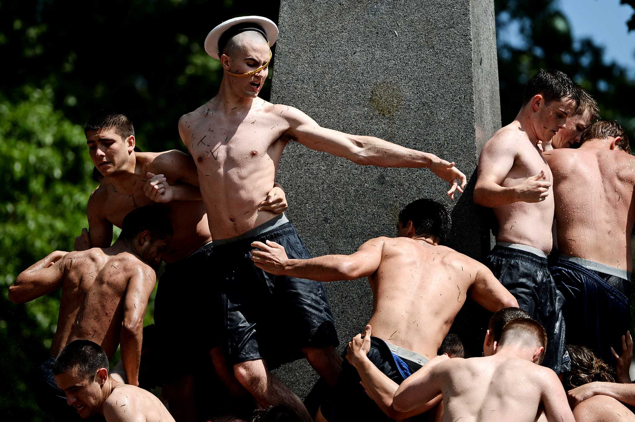 Each year the freshman class, known as 'Plebes,' climb the lard c...