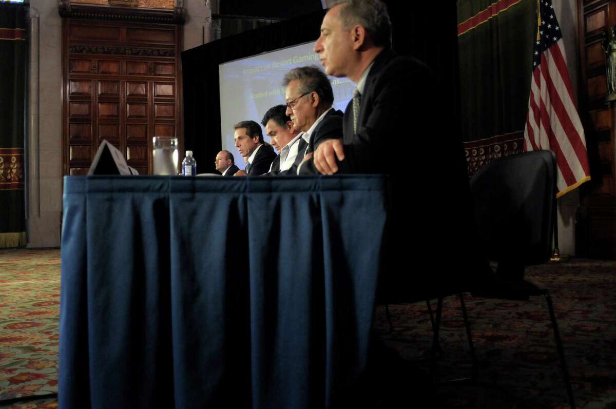 Governor Andrew Cuomo, background center, addresses those gathered during a press event to announce an agreement on gaming with the St. Regis Mohawk Indians, on Tuesday, May 21, 2013 at the Capitol in Albany, NY. Also pictured is Chief Ron LaFrance, third from right, Saint Regis Mohawk Tribal Council, Chief Paul Thompson, second from right, Saint Regis Mohawk Tribal Council, and Howard Glaser, far right, director of State Operations. (Paul Buckowski / Times Union)