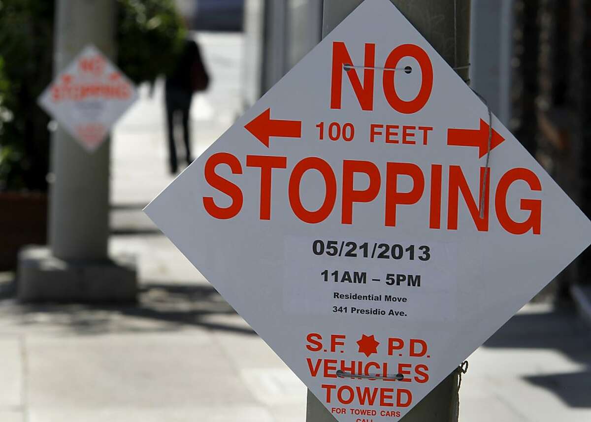 Signs posted for no stopping on Presidio Avenue took up a good portion of the parking on the west side of the street Tuesday May 21, 2013. A parking sign tow-away zone in the 300 block of Presidio Avenue in San Francisco, Calif. was for a residential move but a large portion of the block was posted for no parking.