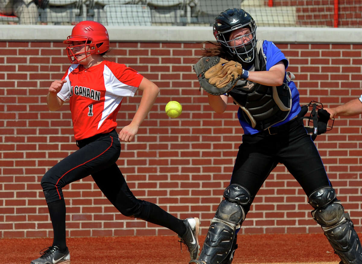 New Canaan's Claire Conley gets past Fairfield Ludlowe catcher Katie Decarlo to score a run, during FCIAC Softball Championship semi-final action at Sacred Heart University in Fairfield, Conn. on Tuesday May 21, 2013.