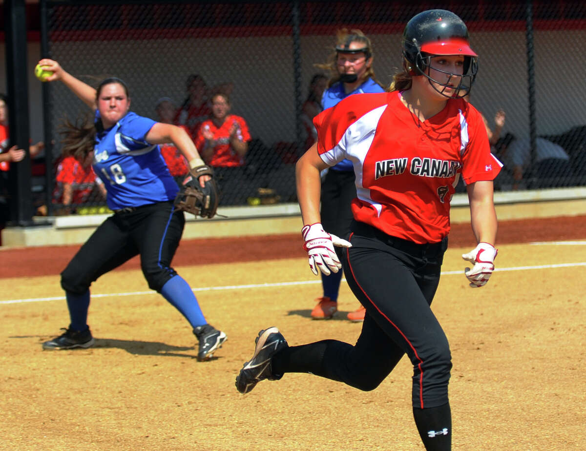 New Canaan's Abby Jenkins heads to first as Fairfield Ludlowe's Brenna Martini fields the ball, during FCIAC Softball Championship semi-final action at Sacred Heart University in Fairfield, Conn. on Tuesday May 21, 2013.