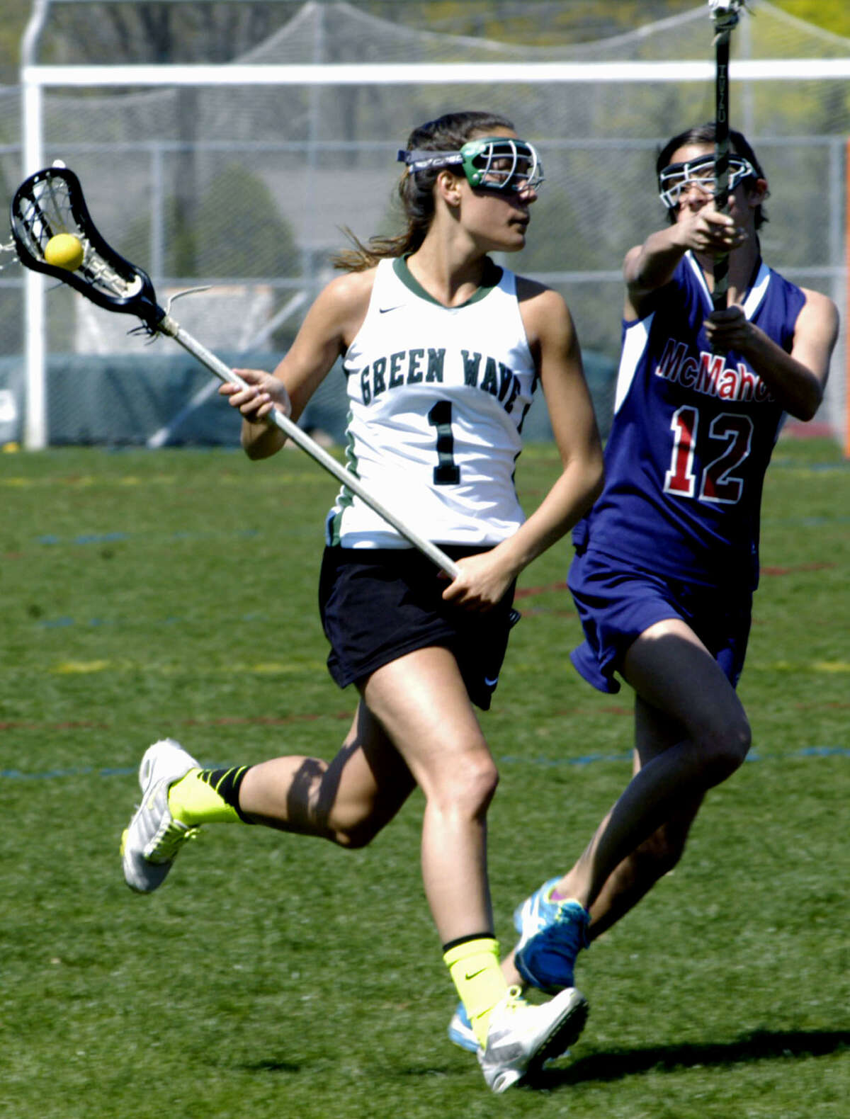 The Green Wave's Destinee Carey surveys the offensive zone for an open teammate during New Milford High School girls' lacrosse's 17-9 victory over Brien McMahon, April 27, 2013 at NMHS.