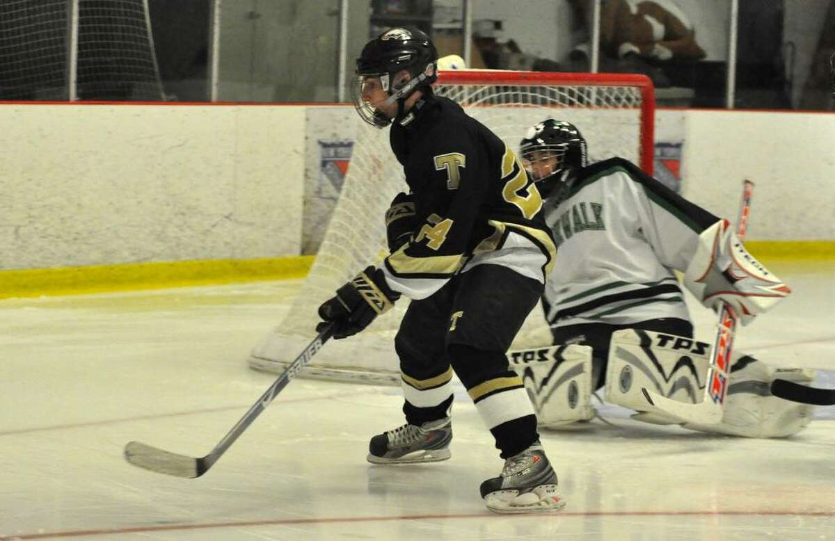 Trumbull High School's Andrew Kelly anticipates the pass before taking a shot on Norwalk/McMahon's goalie Richie Henderson during the third period of the boys ice hockey game at Darien Ice Rink on Monday, Jan. 11, 2010.