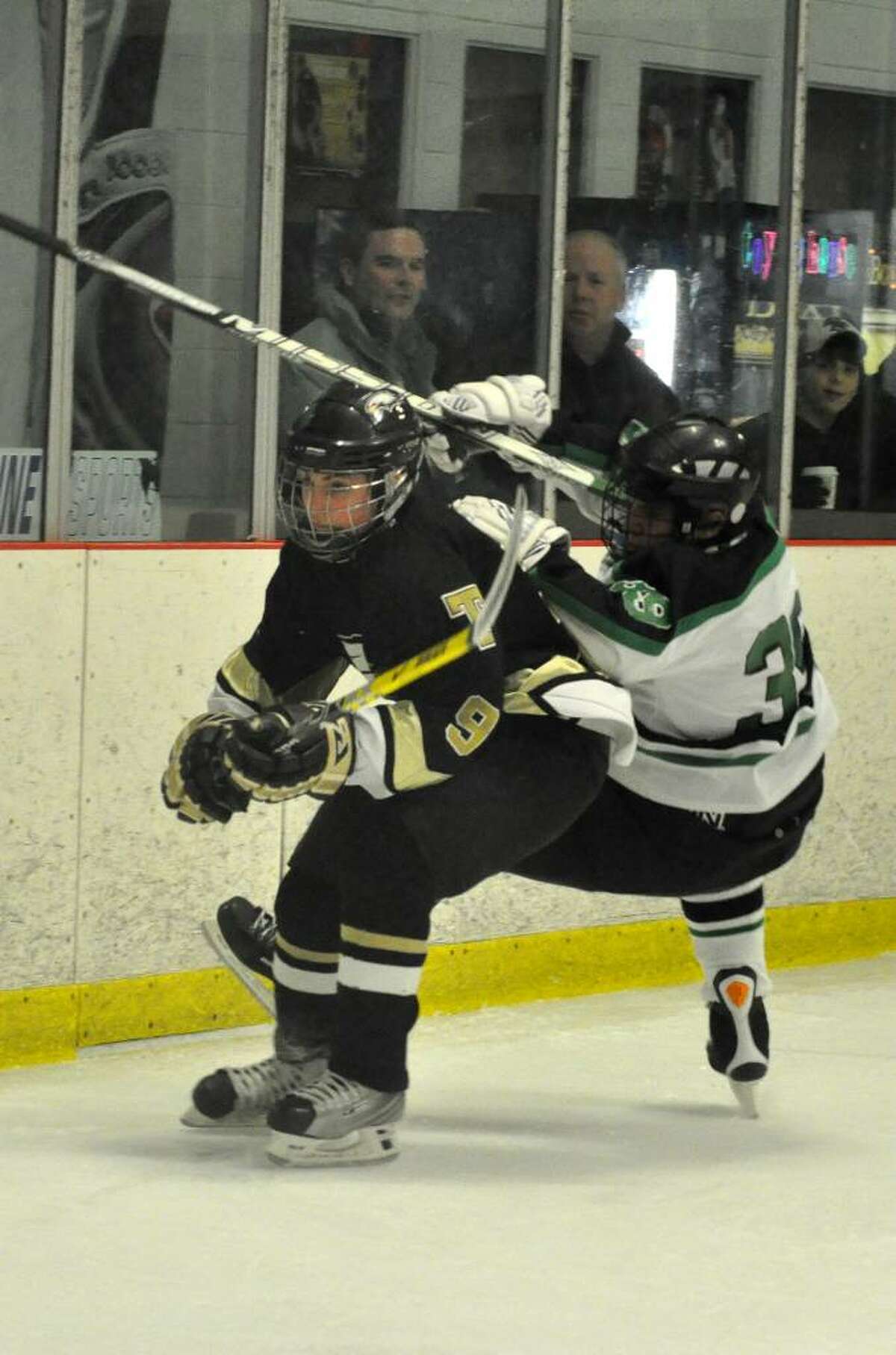 Trumbull High School's AJ DiMasi collides with Norwalk/McMahon's Joe Cox during the boys ice hockey game at Darien Ice Rink on Monday, Jan. 11, 2010.
