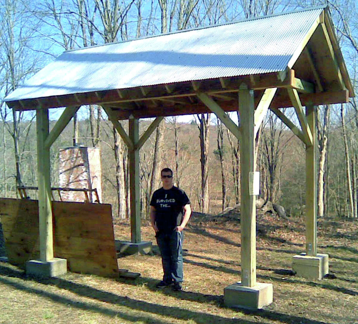 Scott Irwin of Roxbury stands proudly with the structure he built as his Eagle Scout project at the Mine Hill Preserve in Roxbury. May 2013 Courtesy of the Irwin family