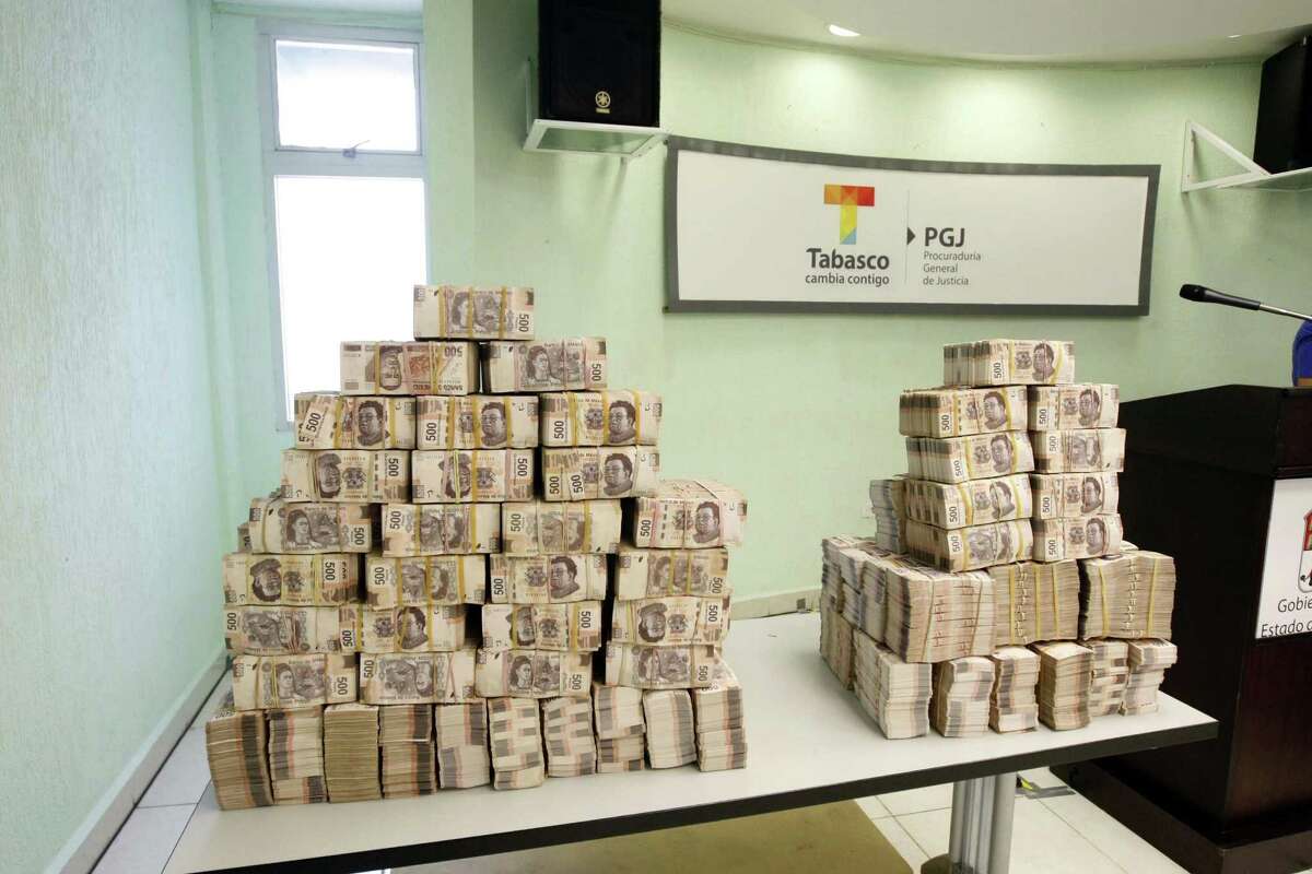 Bundles of 500- and 1,000-peso bills are displayed to the news media after authorities reported finding them Wednesday in an office of José Saiz, who was finance secretary under former Tabasco Gov. Andrés Granier.