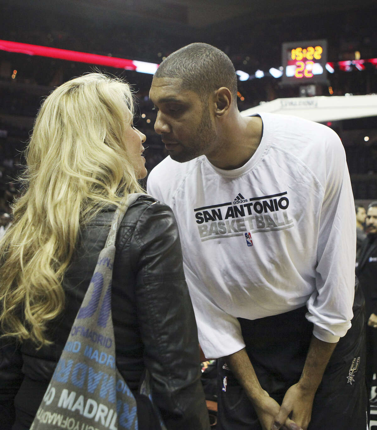 Tim Duncan kisses wife Amy before the start of a preseason game against the Houston Rockets. The couple married in 2001.