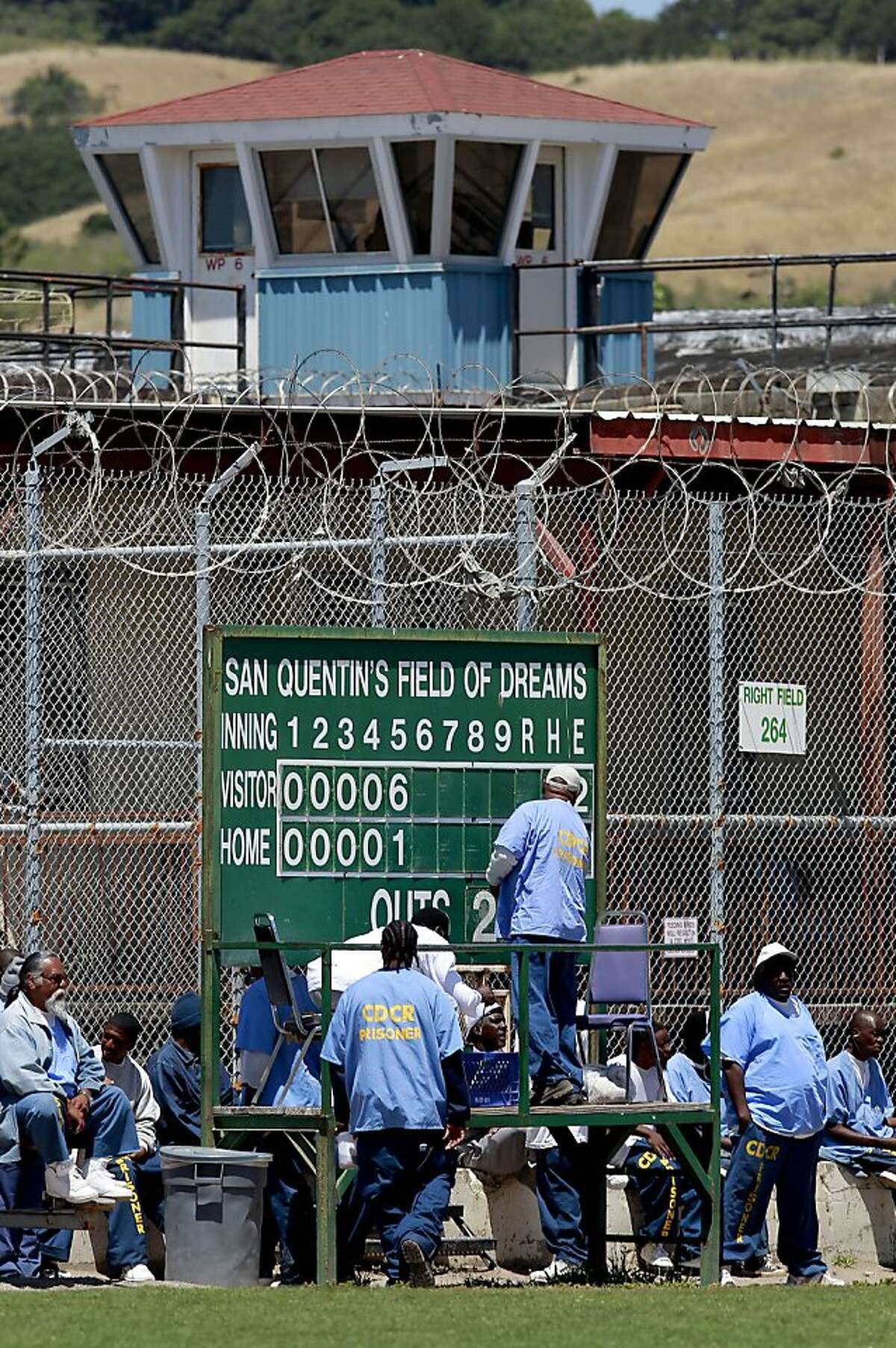 Inmates keeps a close watch and tend to the centerfield score board as the San Quentin Giants play the San Rafael Pacifics in a game at San Quentin prison in San Rafael, Calif. on Sat. May 18, 2013. The San Rafael Pacifics baseball club take on the San Quentin Giants at historic San Quentin prison as the Pacifics went on to finish the day with a spring training victory beating the Giants 17-3.