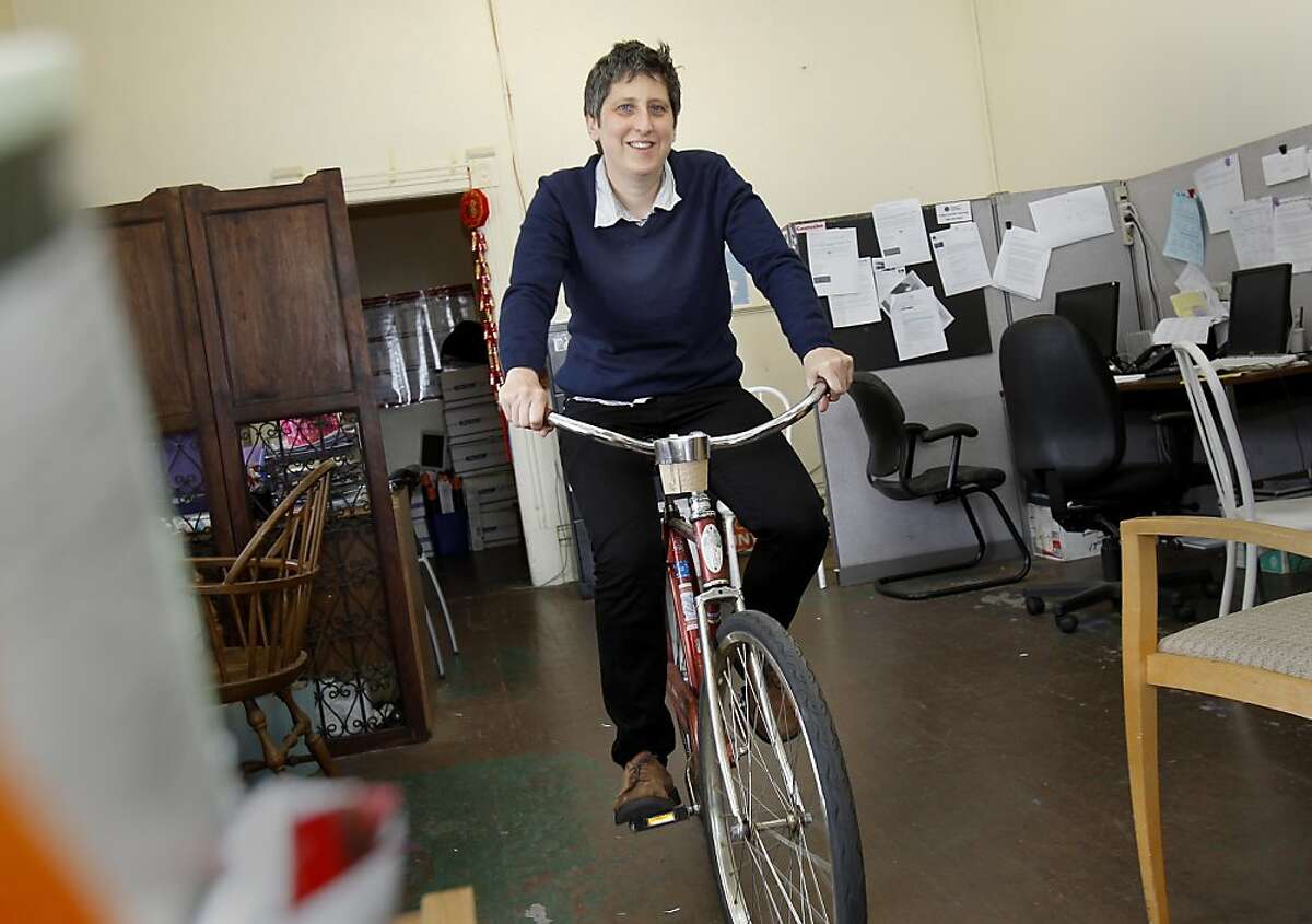 Sara Shortt pedals her bike through her offices on South Van Ness Avenue. Sara Shortt is executive director of the Housing Rights Committee of San Francisco, Calif. She rides her bike to City Hall for meetings Thursday April 25, 2013.