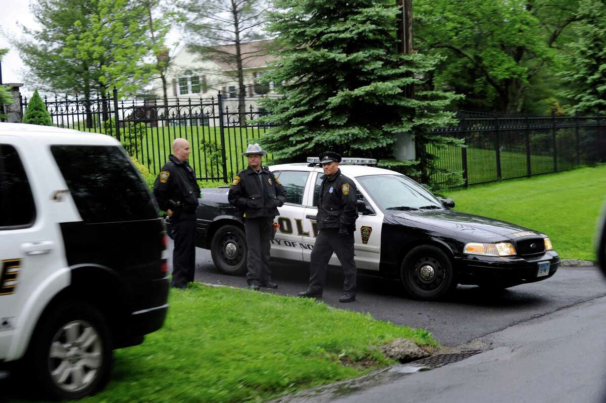 Norwalk Police, called in to assist the Ridgefield Police, guard the front gate of a home at 423 Ridgebury Rd in Ridgefield, Conn. where a shooting occurred Friday evening, May 24, 2013.