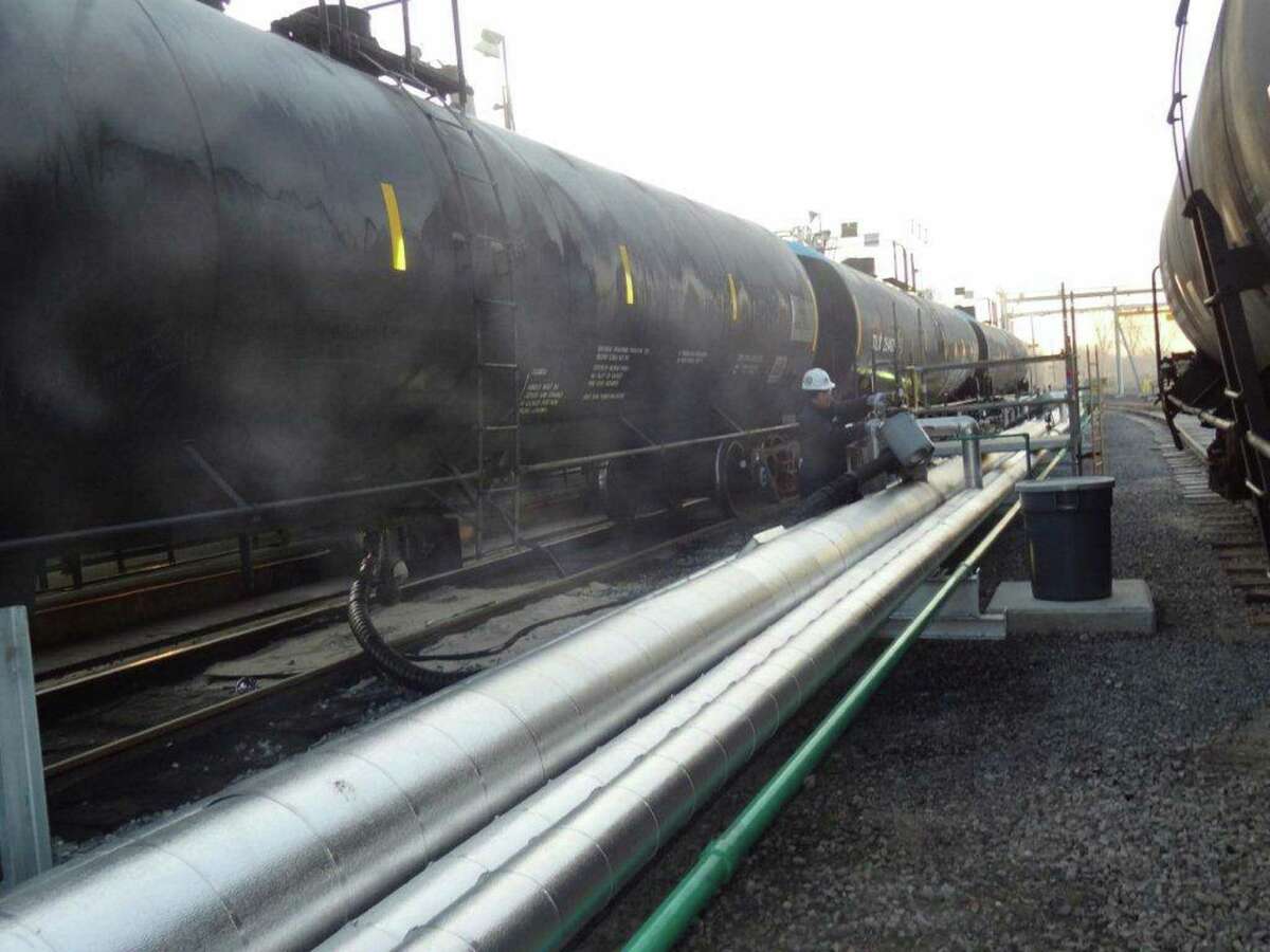 Heated heavy Canadian oil is transferred from rail cars into pipelines for processing at a NuStar Asphalt joint-venture refinery in Paulsboro, N.J.
