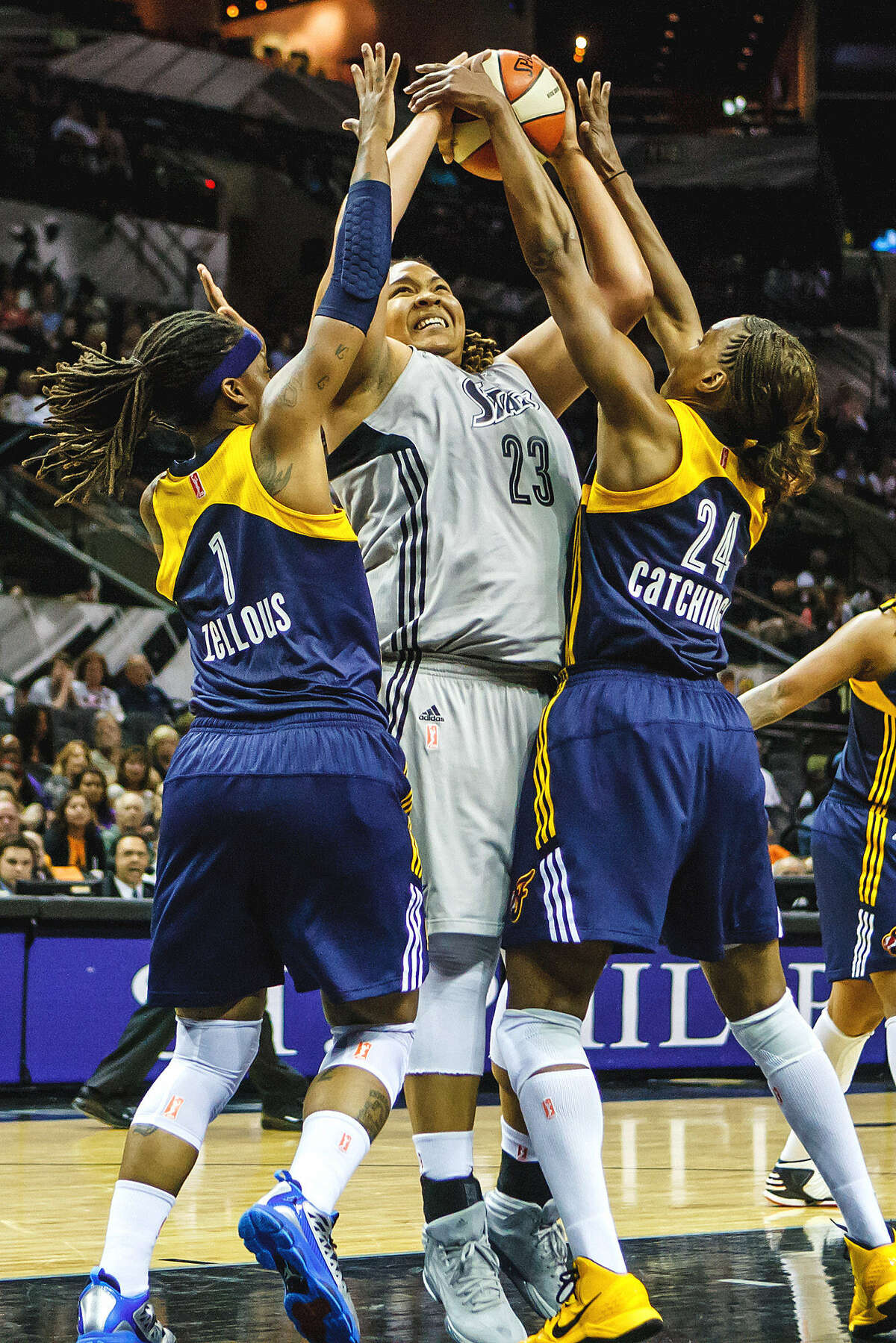 Shavonte Zellous (left) and Tamika Catchings, who each scored 19 points for Indiana, defend the Silver Stars' Danielle Adams.