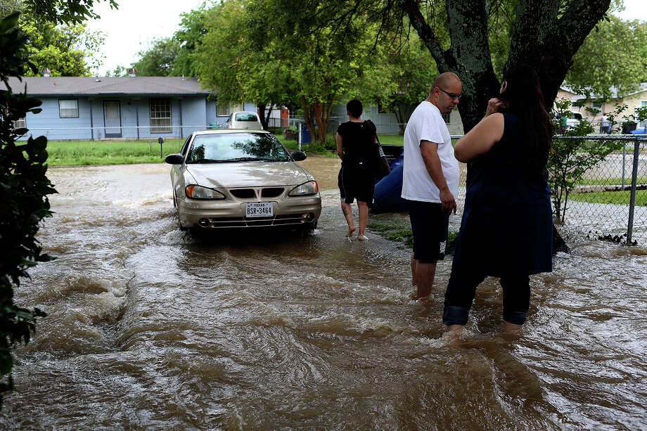 Flooding claims at least two lives; ‘downpours’ remain in forecast ...