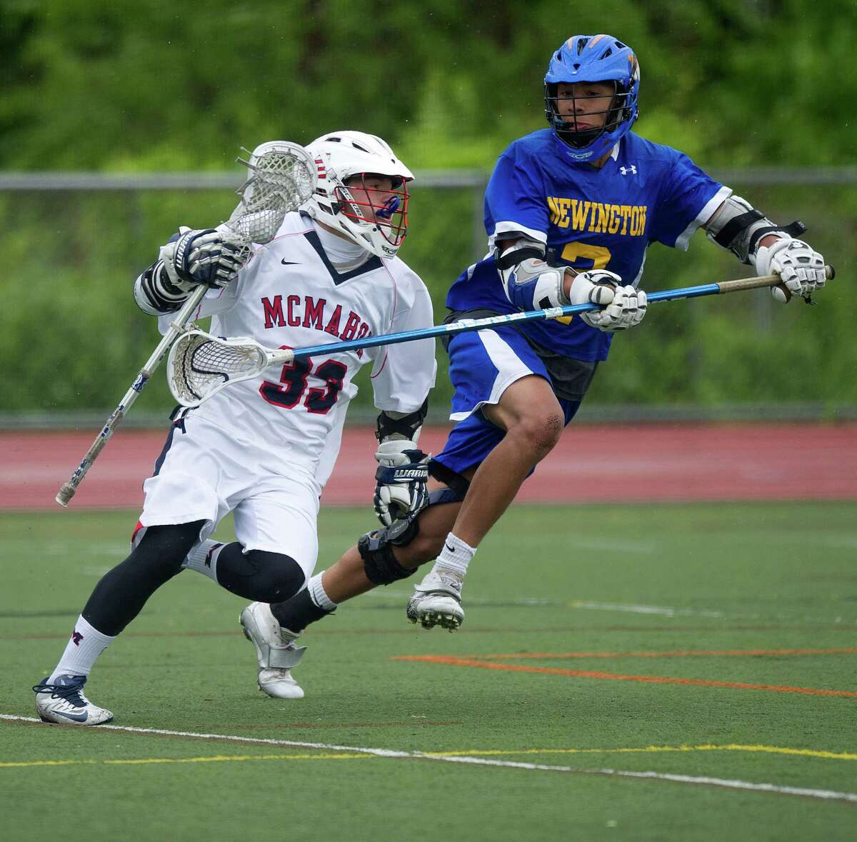 Brien McMahon's Andrew D'Antonio controls the ball as he is defended by Newington's John Massaro during Saturday's Boys Lacrosse State Tournament qualifying round class L in Norwalk, Conn., on May 25, 2013.