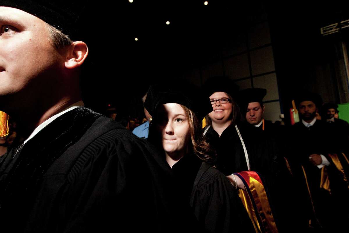 Loren Jones walks into the graduation ceremony before graduating from the South Texas College of Law at the George R. Brown Convention Center Saturday, May 25, 2013, in Houston.